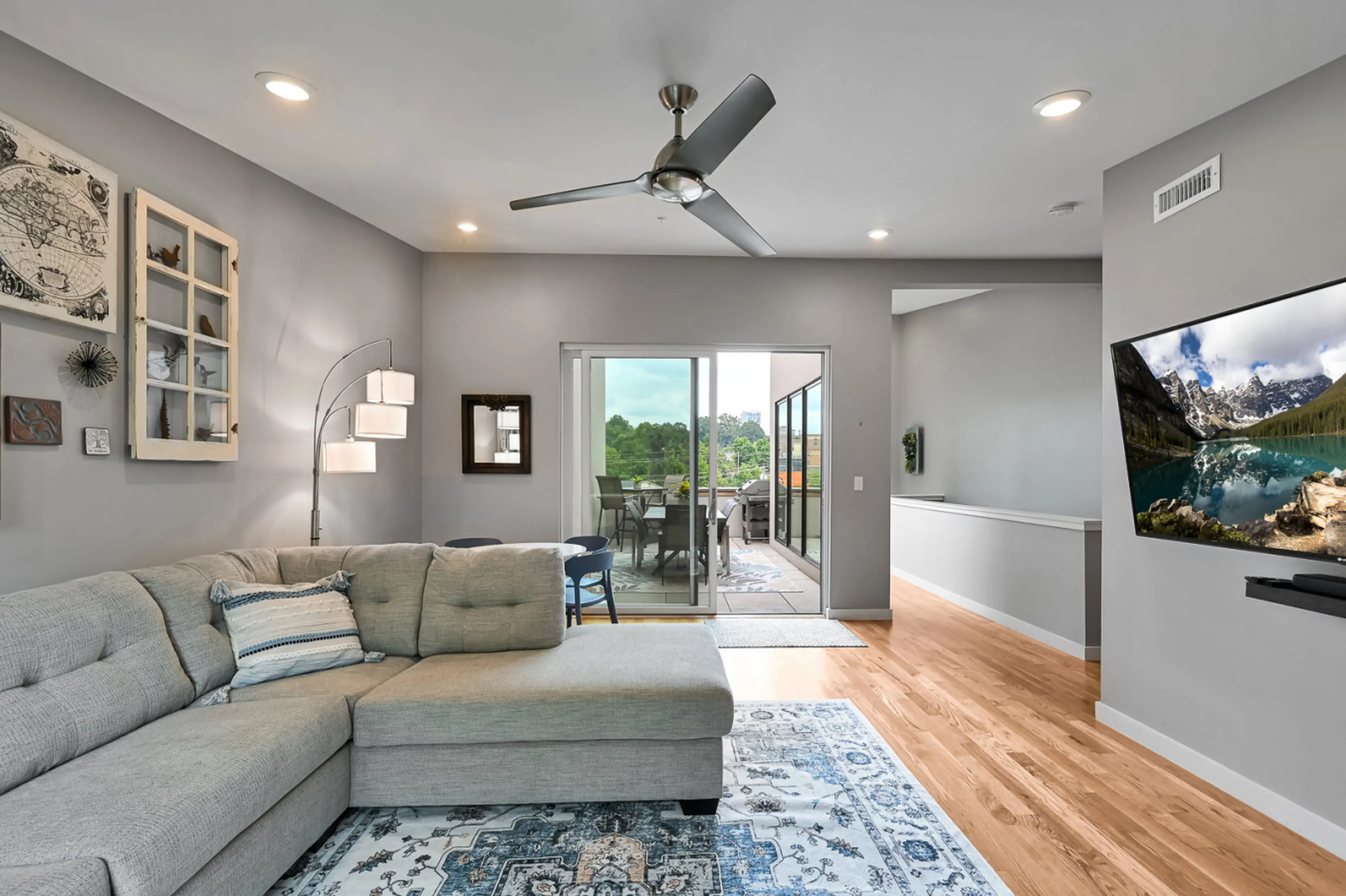 Loft den with surround sound TV, game table, and terrace with gas grill