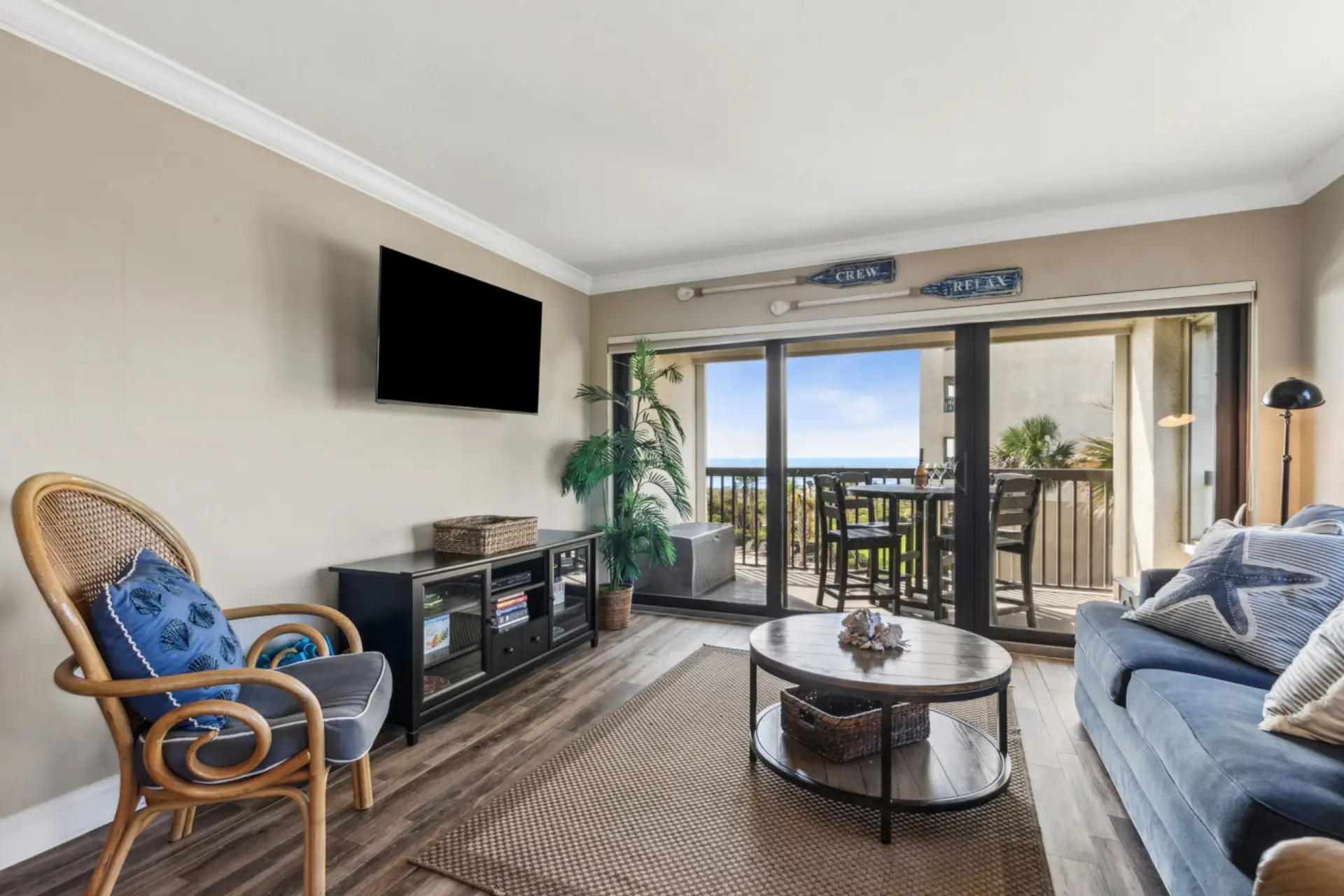 Living room with cable tv and sliding glass door to balcony