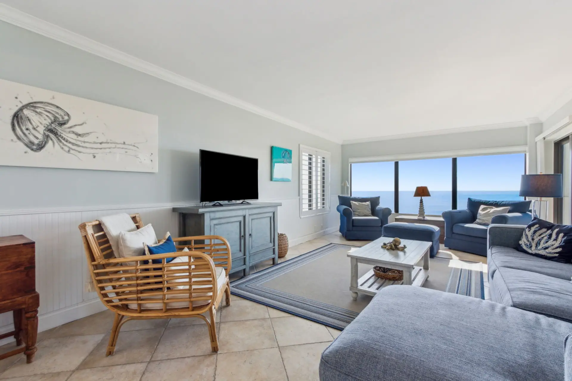 Living room with cable tv and sliding glass door to balcony