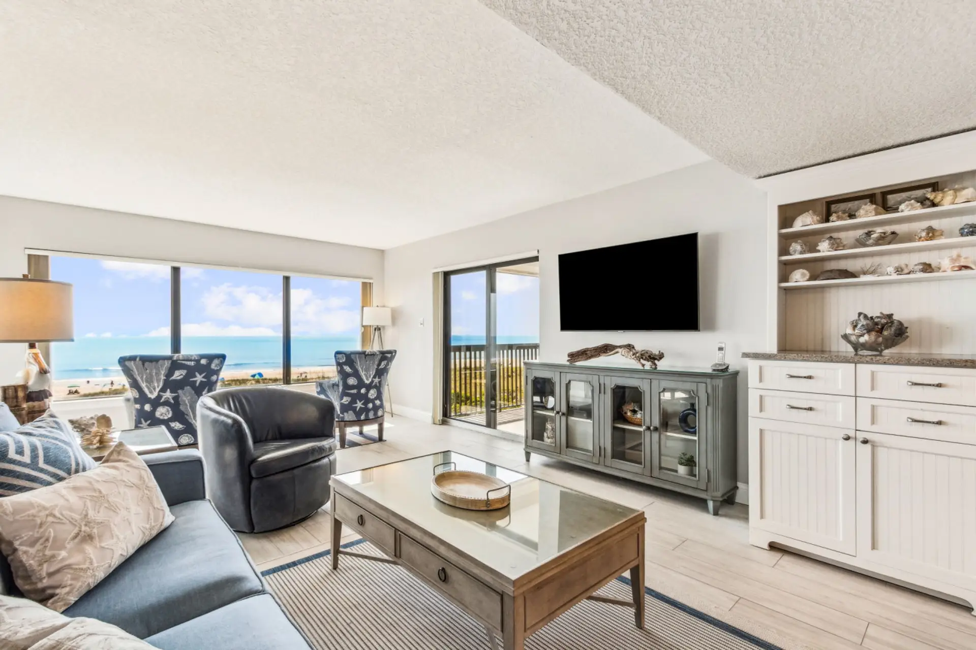 Living room with cable tv and sliding door to balcony