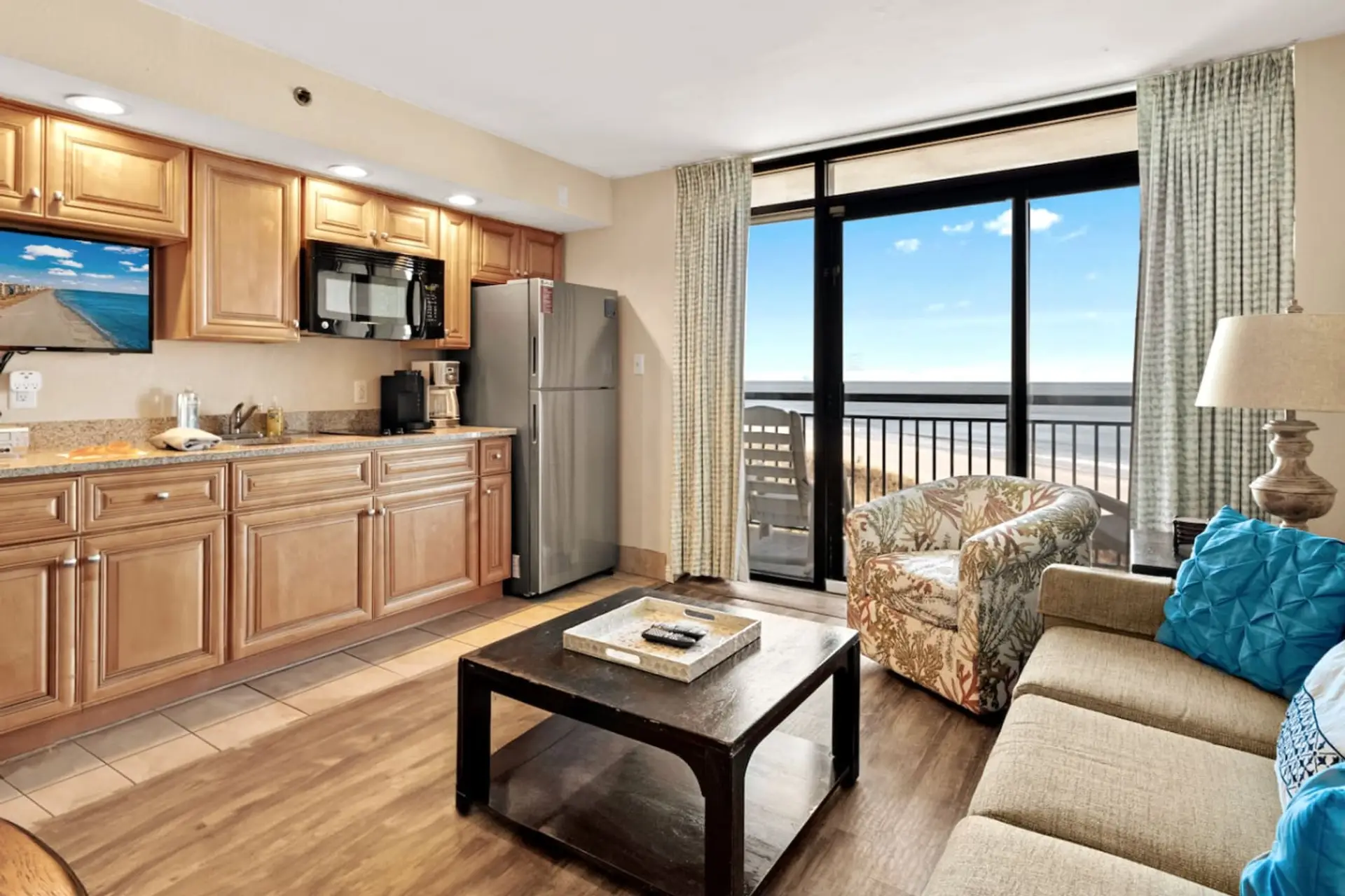 Low-floor oceanfront living room with direct beach views, comfy seating, and a smart TV for movie nights in.