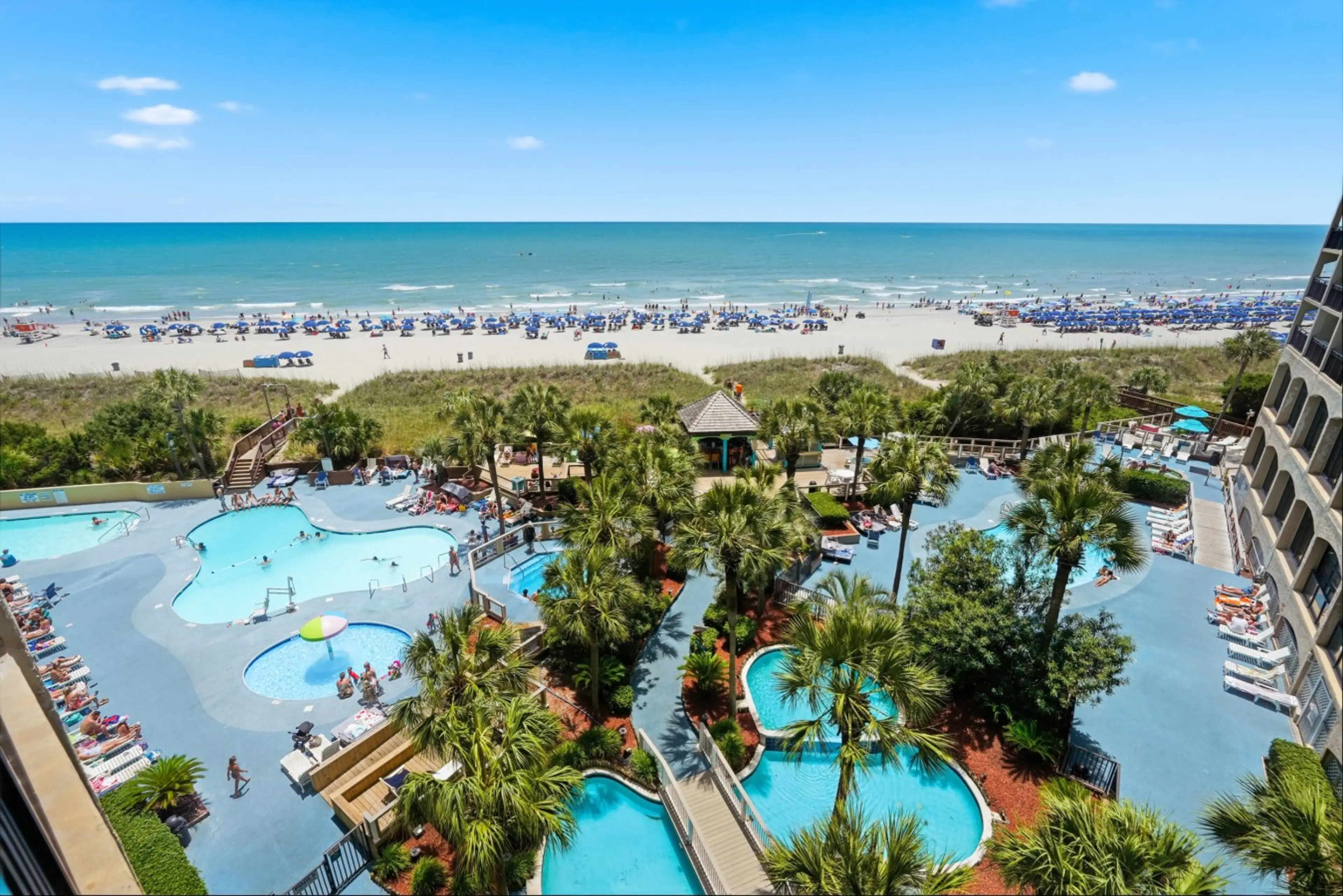 Enjoy panoramic views of the North Myrtle Beach shoreline from your private oceanfront balcony overlooking Beach Cove Resort's tropical pools, lazy river, hot tubs, and lush landscaping. The perfect spot for sunrise coffee or evening relaxation.