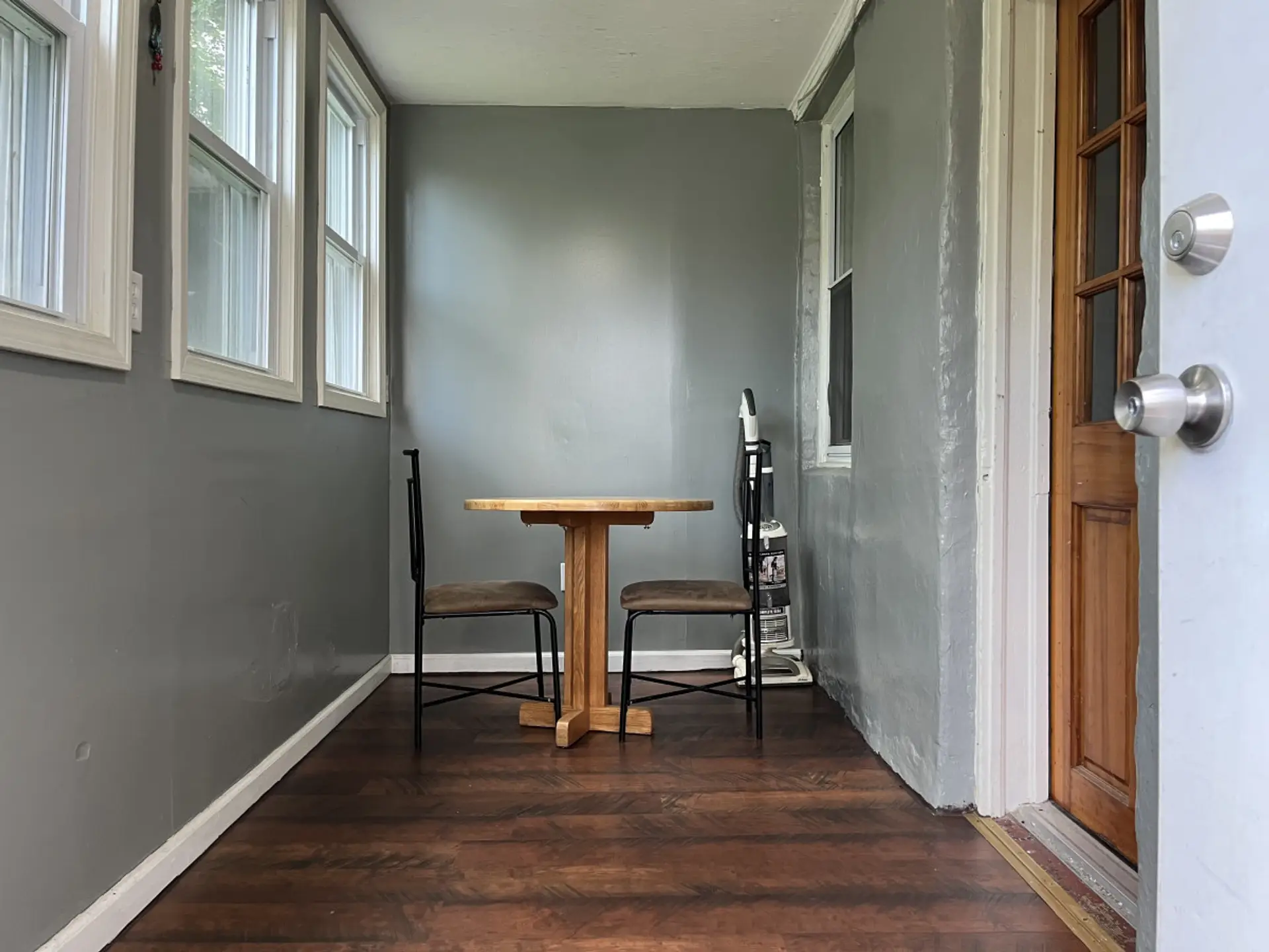 Enclosed porch to enter the kitchen.  Enjoy your coffee and breakfast in this peaceful atmosphere.