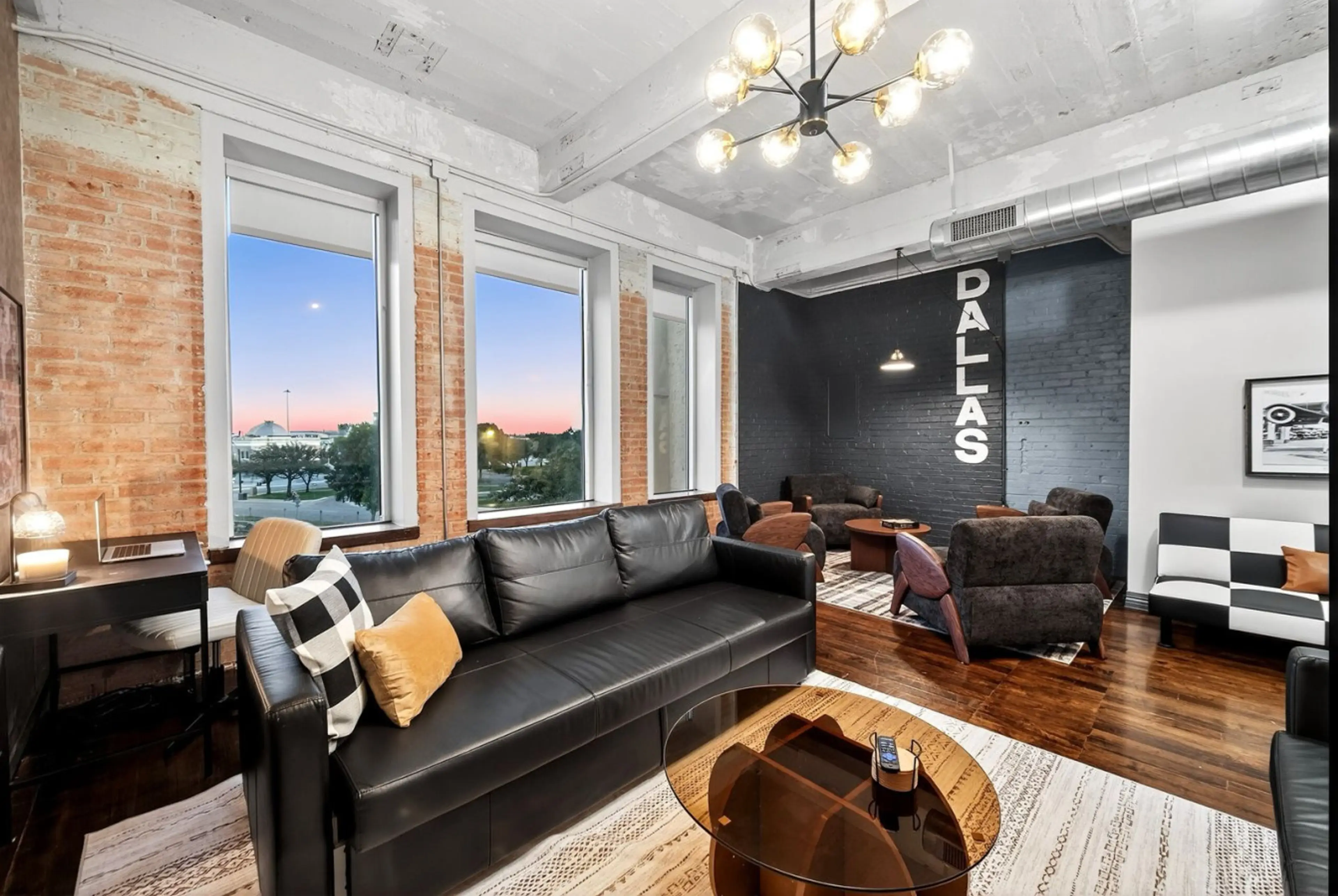 Unique Decor: Classic jukebox, abstract artwork, and a “DALLAS” mural wall emphasize both local pride and retro automotive culture.