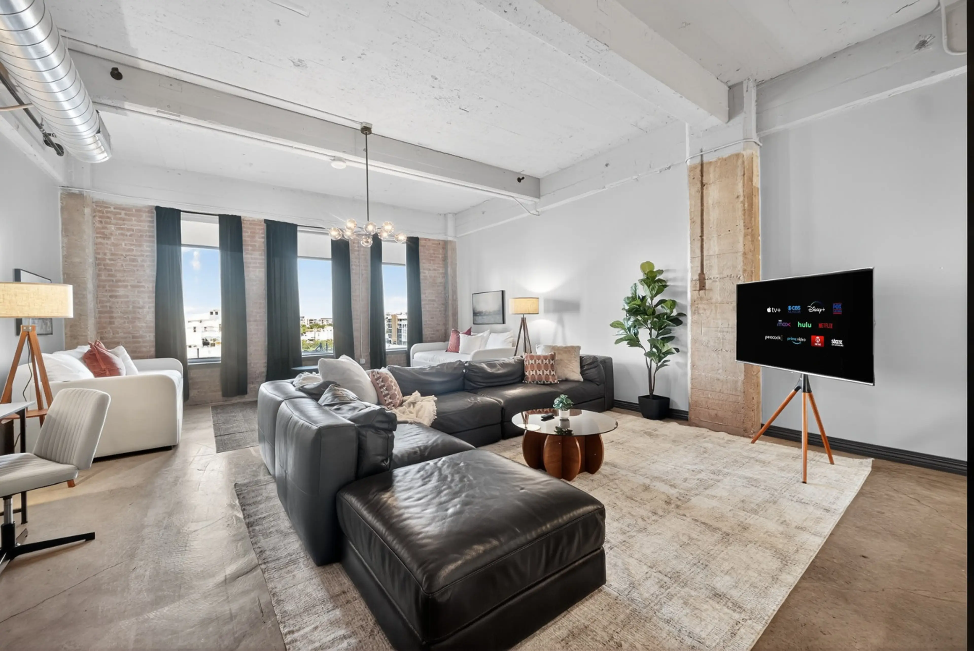 Gather & Relax – Oversized leather sectional and streaming-ready TV for ultimate comfort.