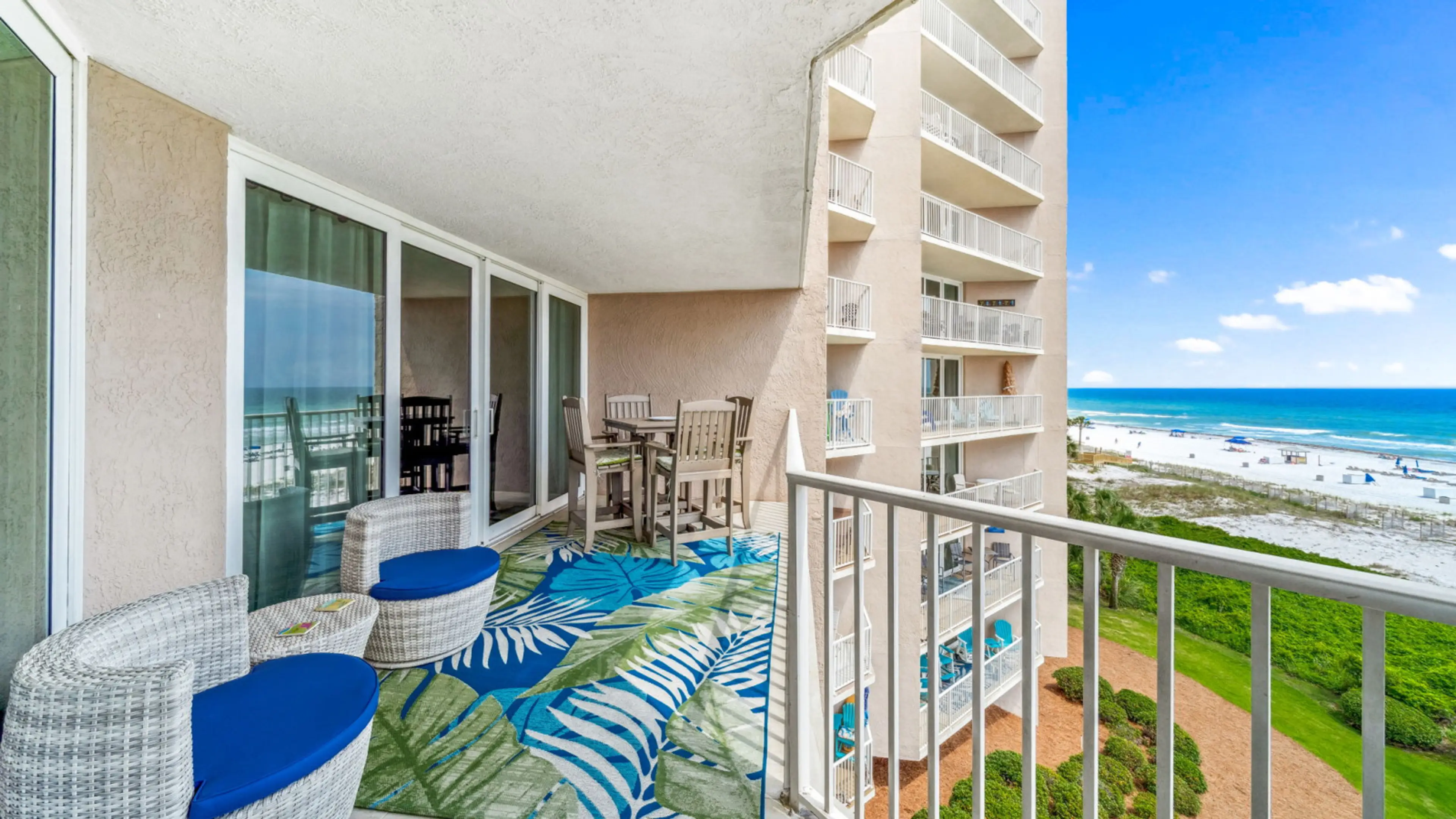 Step onto your private balcony and soak in the stunning Gulf views from this spacious outdoor retreat. Outfitted with stylish wicker seating, plush blue cushions, and a tropical area rug, this space is perfect for morning coffee, evening cocktails, or sim
