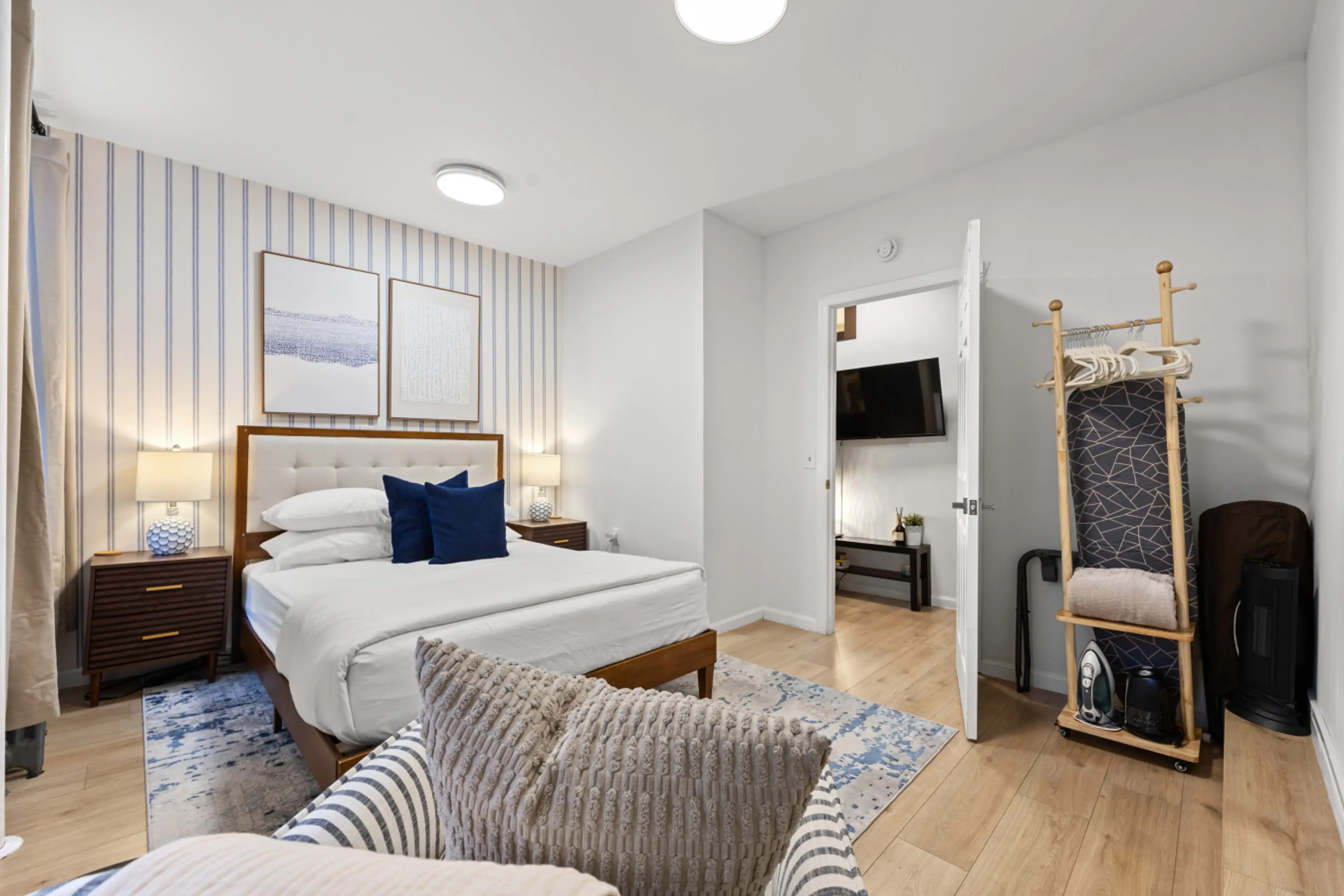 Spacious bedroom with a comfy queen bed, extra seating, open storage, and a TV just steps away. Perfect for unwinding.