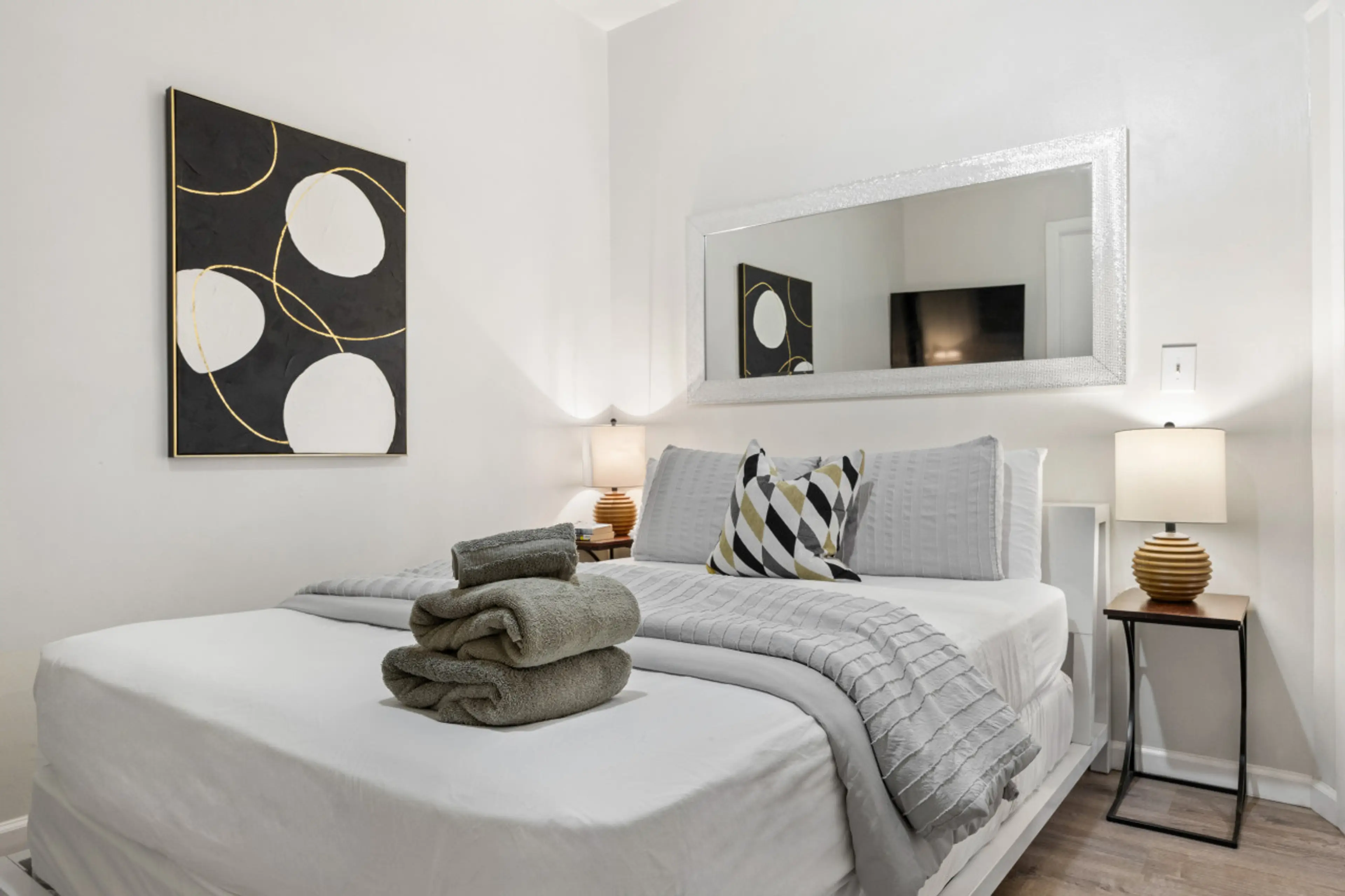 Serene sanctuary: Master bedroom with en-suite bathroom, TV, and window AC unit.