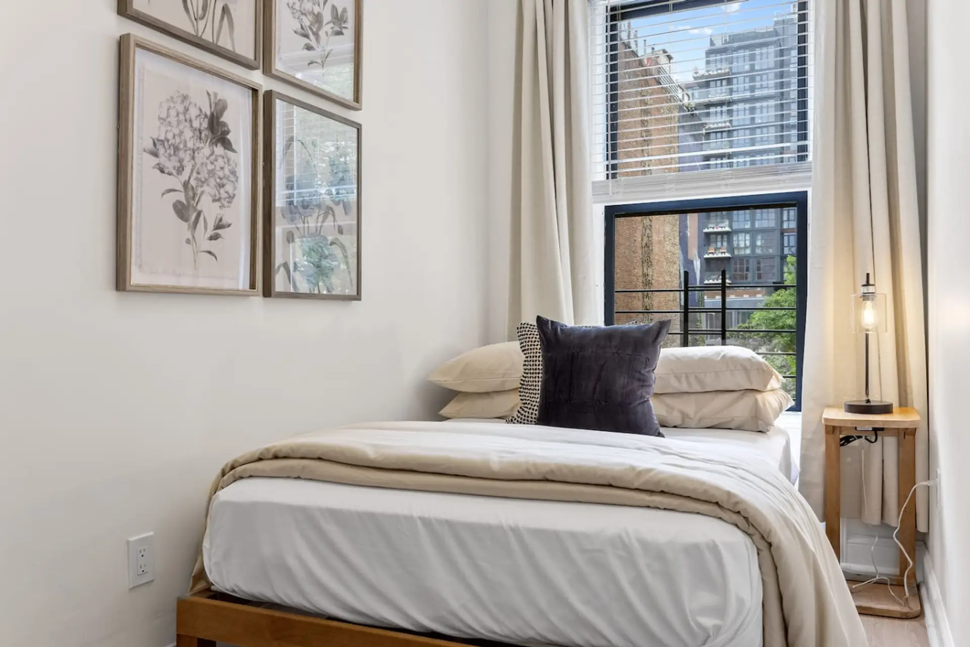 Settle into this comfy, sunlit bedroom during your stay! You'll find a plush bed and a peaceful vibe, with just enough of a glimpse of the city outside your window.