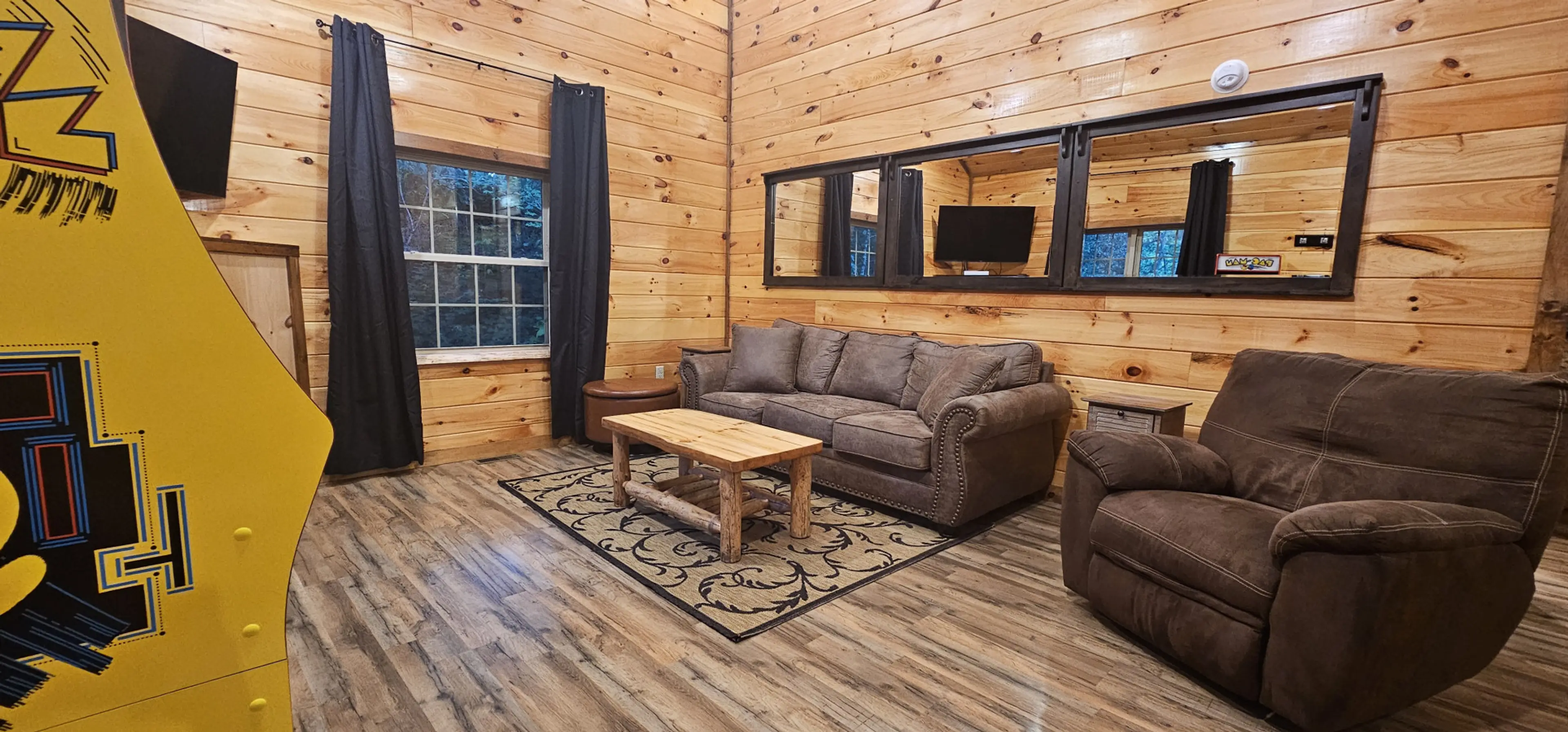 Unwind in our cozy living room, equipped with a nostalgic Pac-Man arcade, a warm electric fireplace, and a smart TV with Wi-Fi—perfect for movie nights. The comfortable sleeper sofa expands your space for added rest.