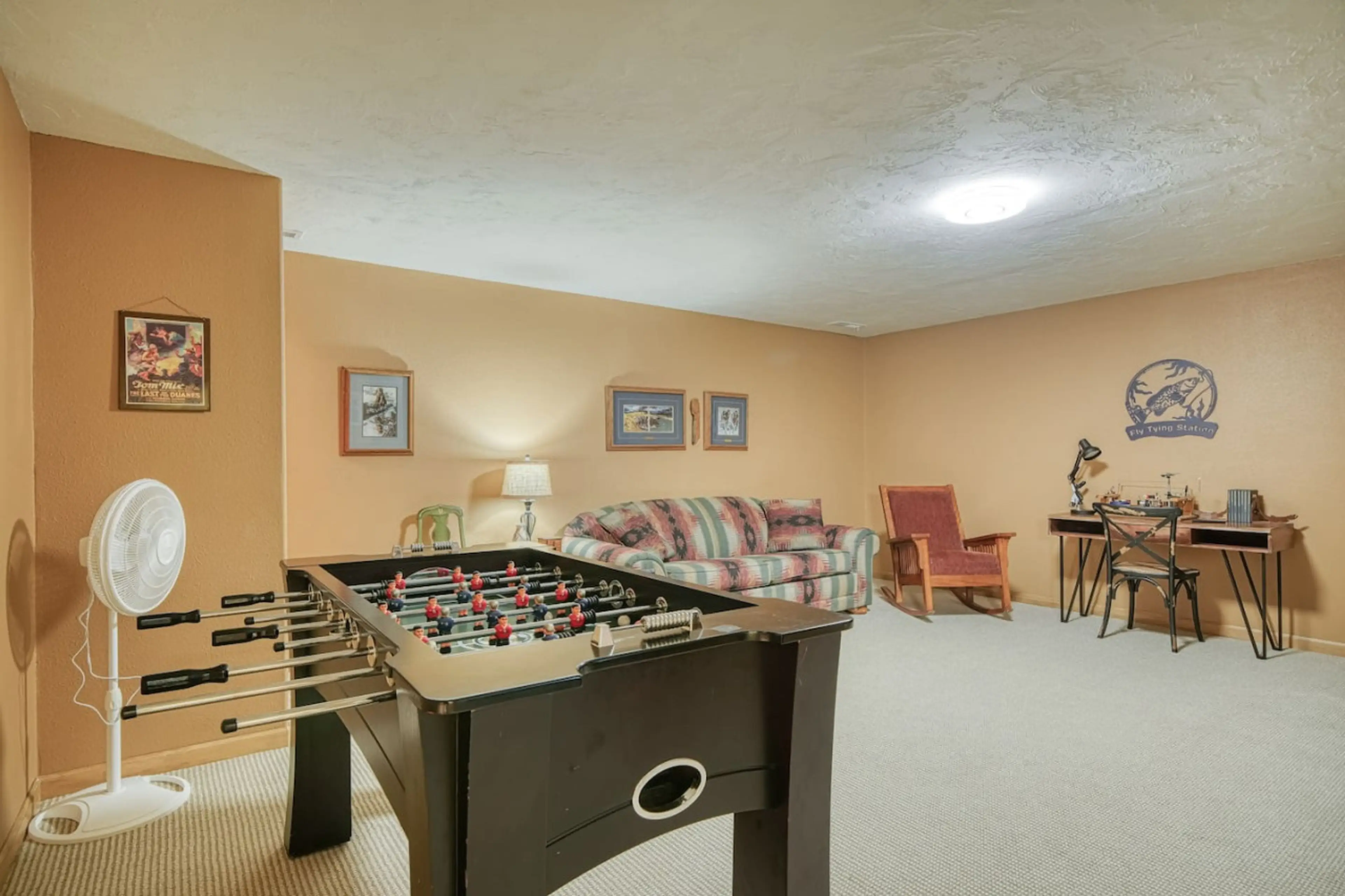 Cozy basement with foosball table and seating area