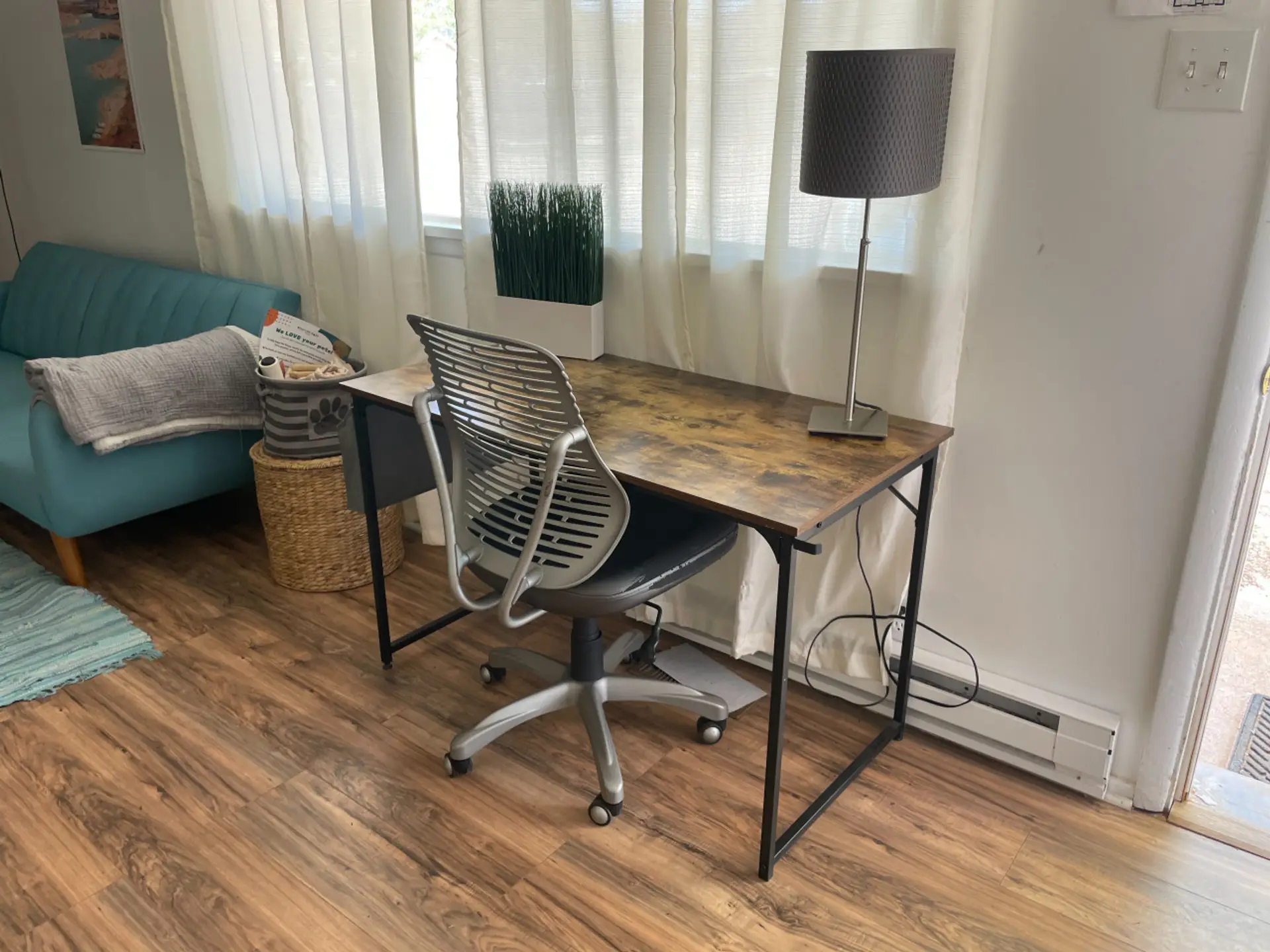 Comfortable workspace with a desk, chair, and nearby seating.