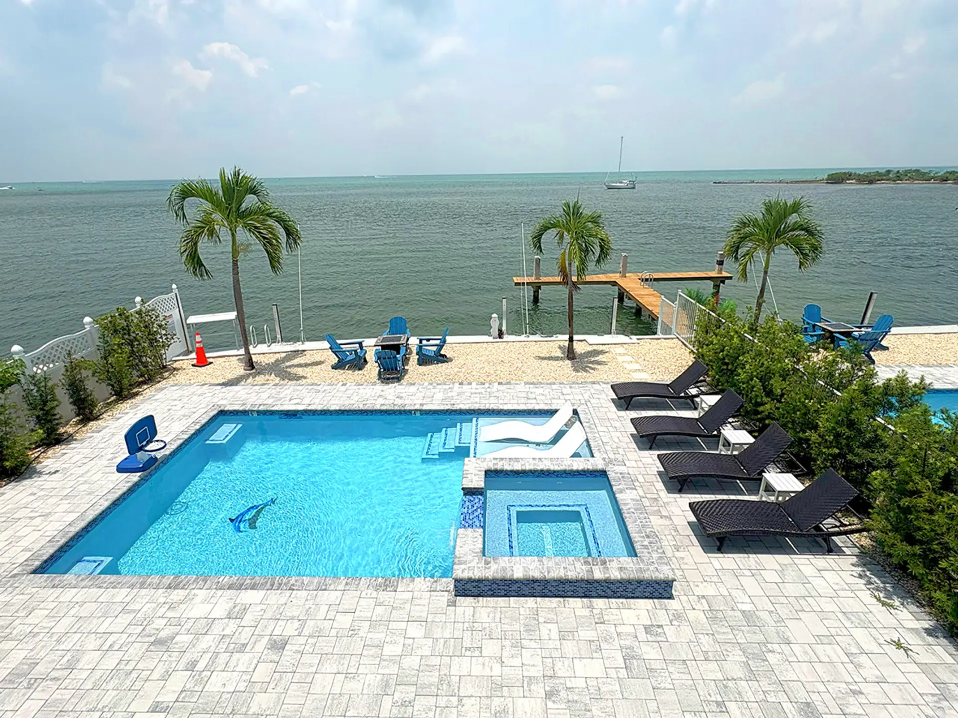 Waterfront Luxury | Heated Pool, Spa & Dock Access Bask in the sun by the serene oceanfront pool. Enjoy the spacious sundeck, jacuzzi, and peaceful views—perfect for families or couples seeking relaxation with luxury finishes.
