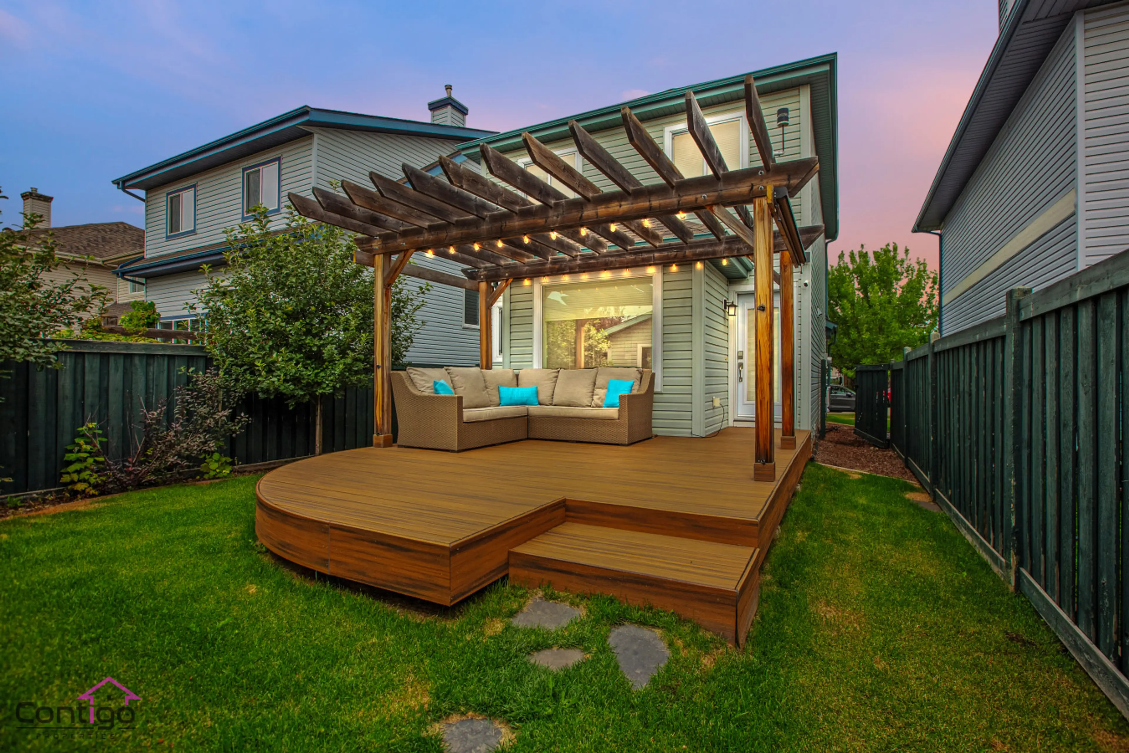Spacious backyard deck with comfy outdoor furniture – perfect for sunset lounging or morning coffee.