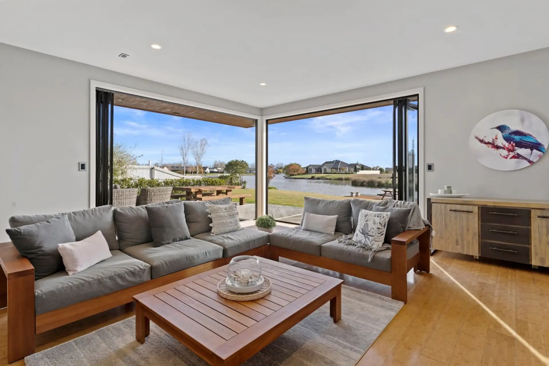 A welcoming lounge seamlessly connects to the outside space and down to the private jetty..