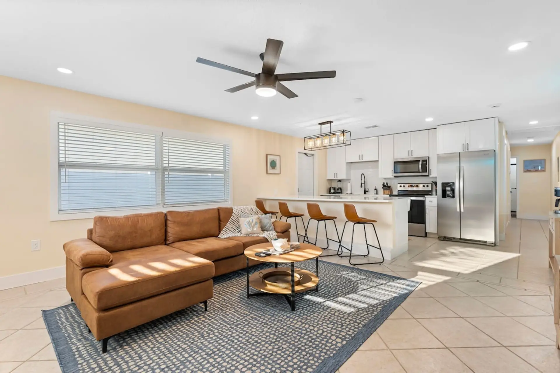 Cocoa Beach Living Space | Breezy Coastal Retreat with Sectional Sofa, Sleek Waterfall Island & Leather Bar Seating