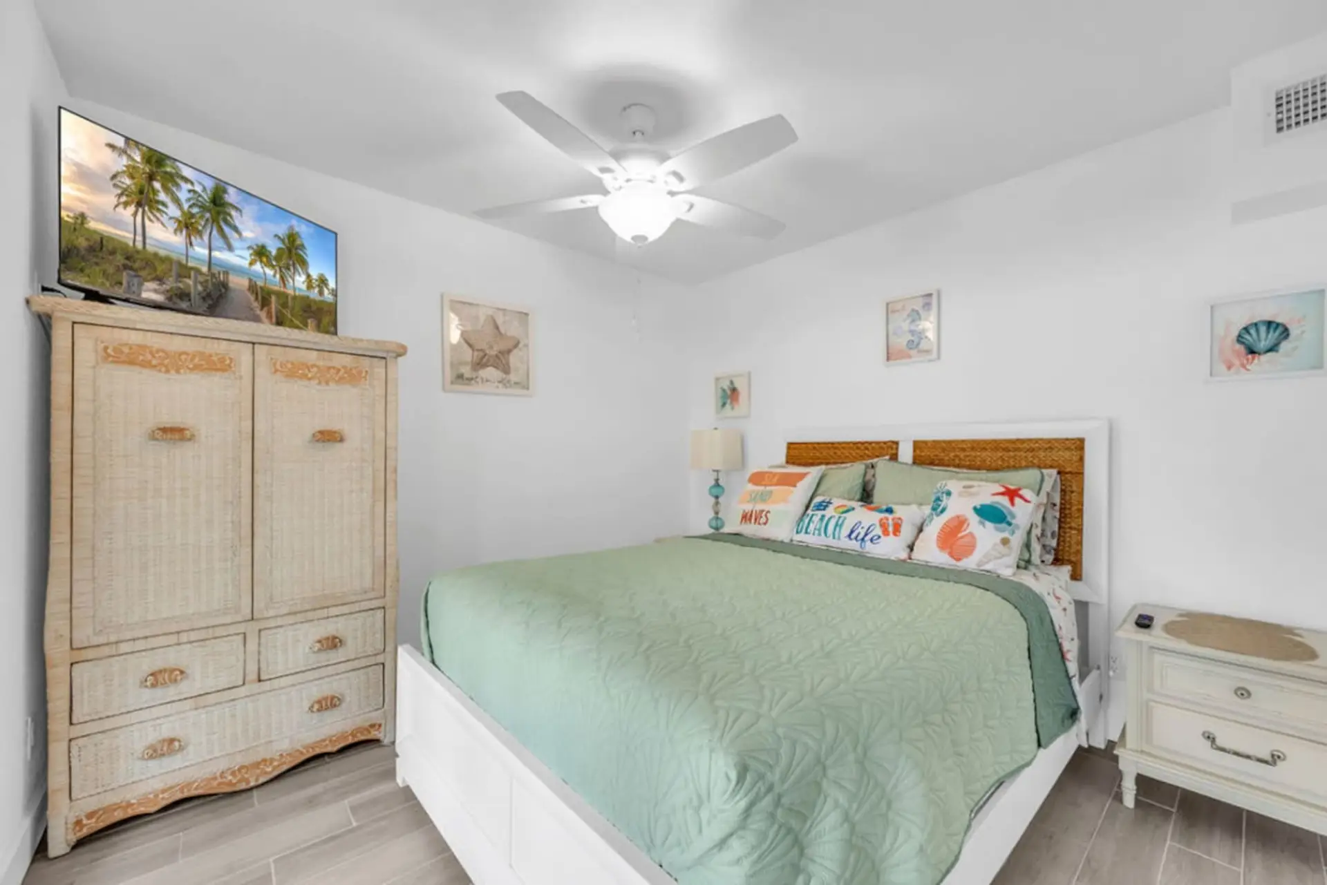 The Melbourne, FL retreat offers a cozy bedroom with a queen bed, fan, heating, clothing storage, TV & more.