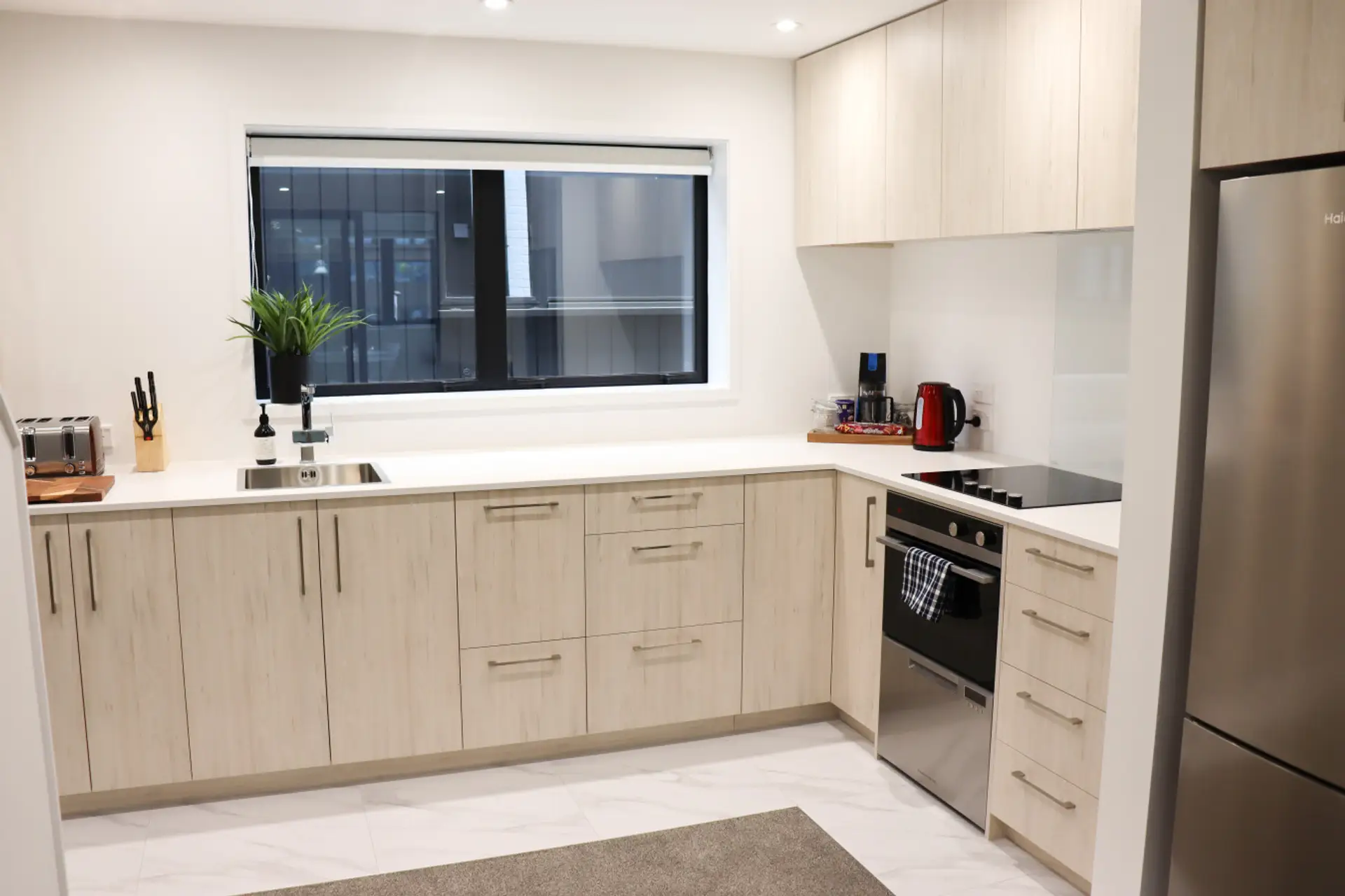 Fully equipped kitchen featuring a built-in oven, stovetop, cookware, and all the essentials for home cooking.