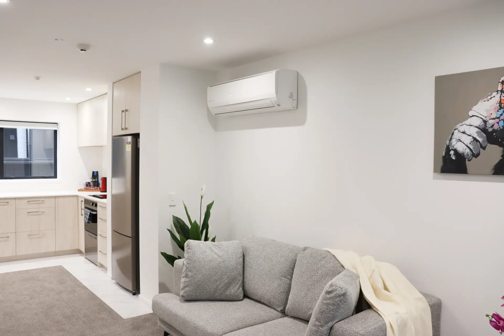Bright and comfortable living room with a cozy sofa, smart TV, and space to relax after a day out.