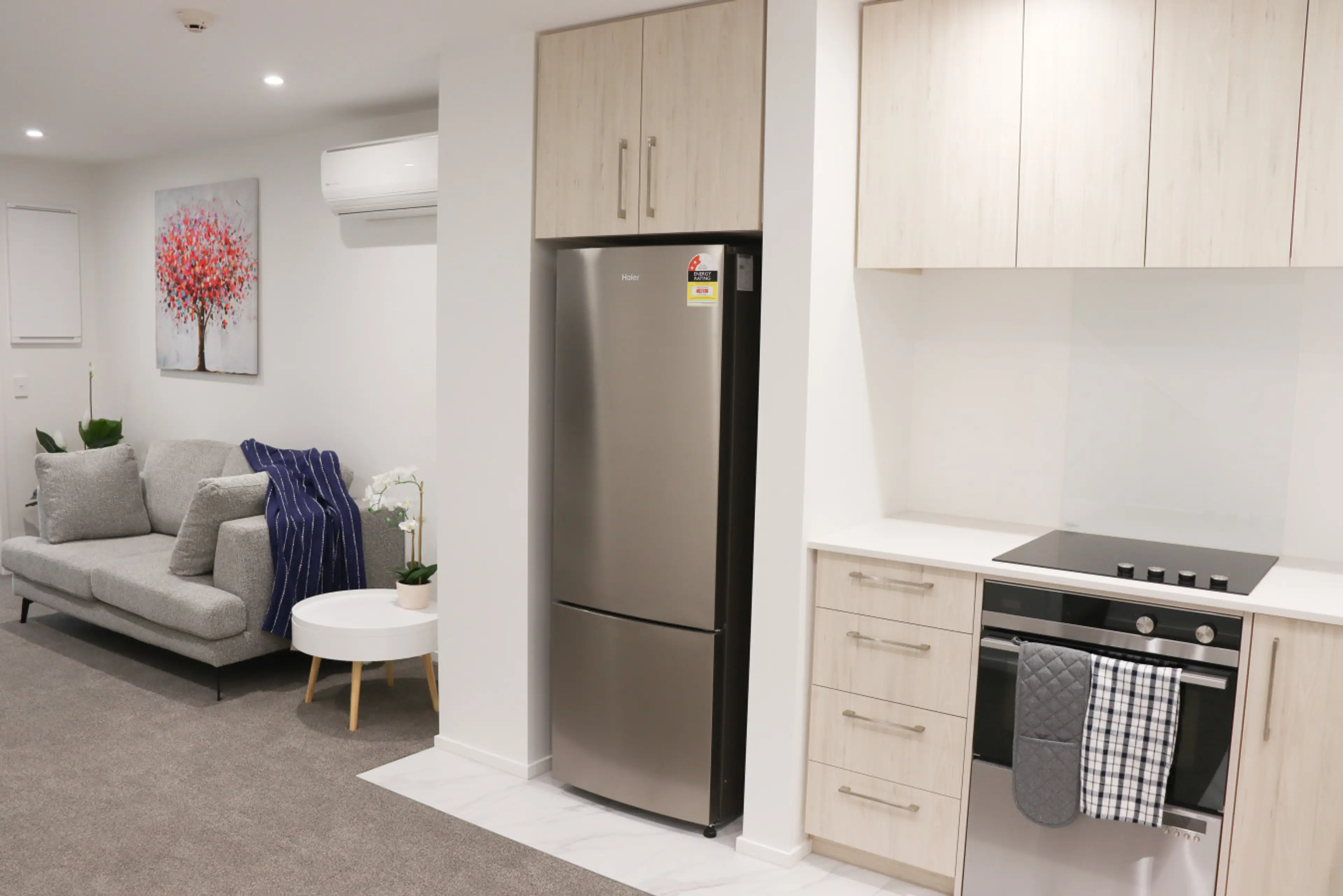 Spacious living area with a cozy sofa, stylish decor, and plenty of natural light—ideal for relaxing and unwinding.