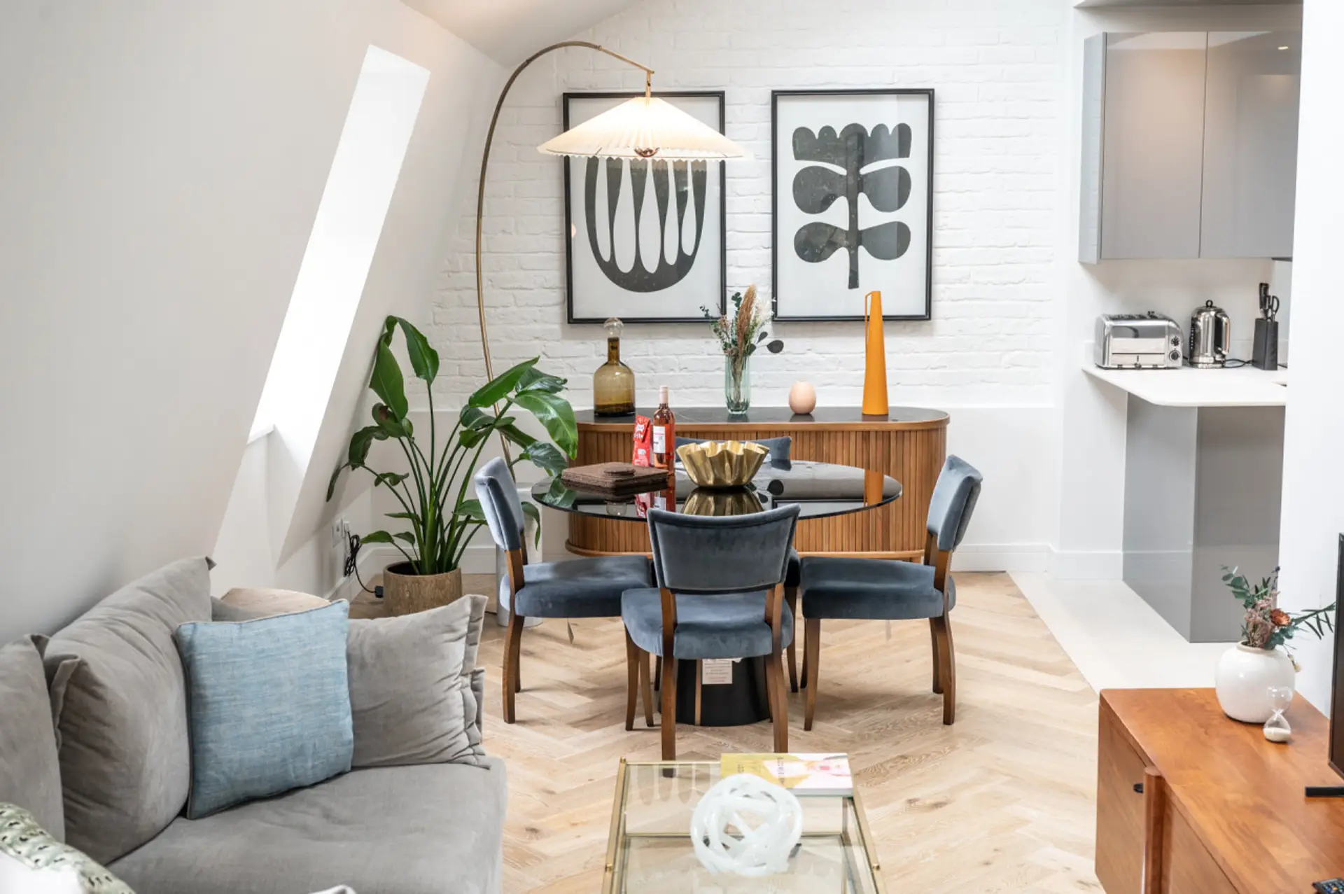 Open plan bright living area on the top floor leading into kitchen.
