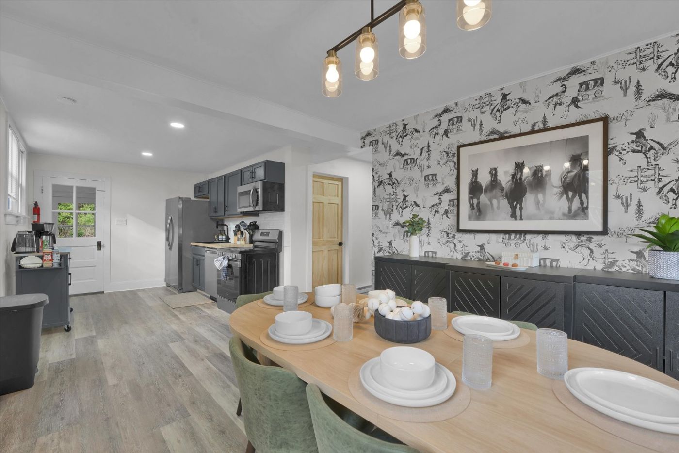 Kitchen and dining table in front of a stone feature wall