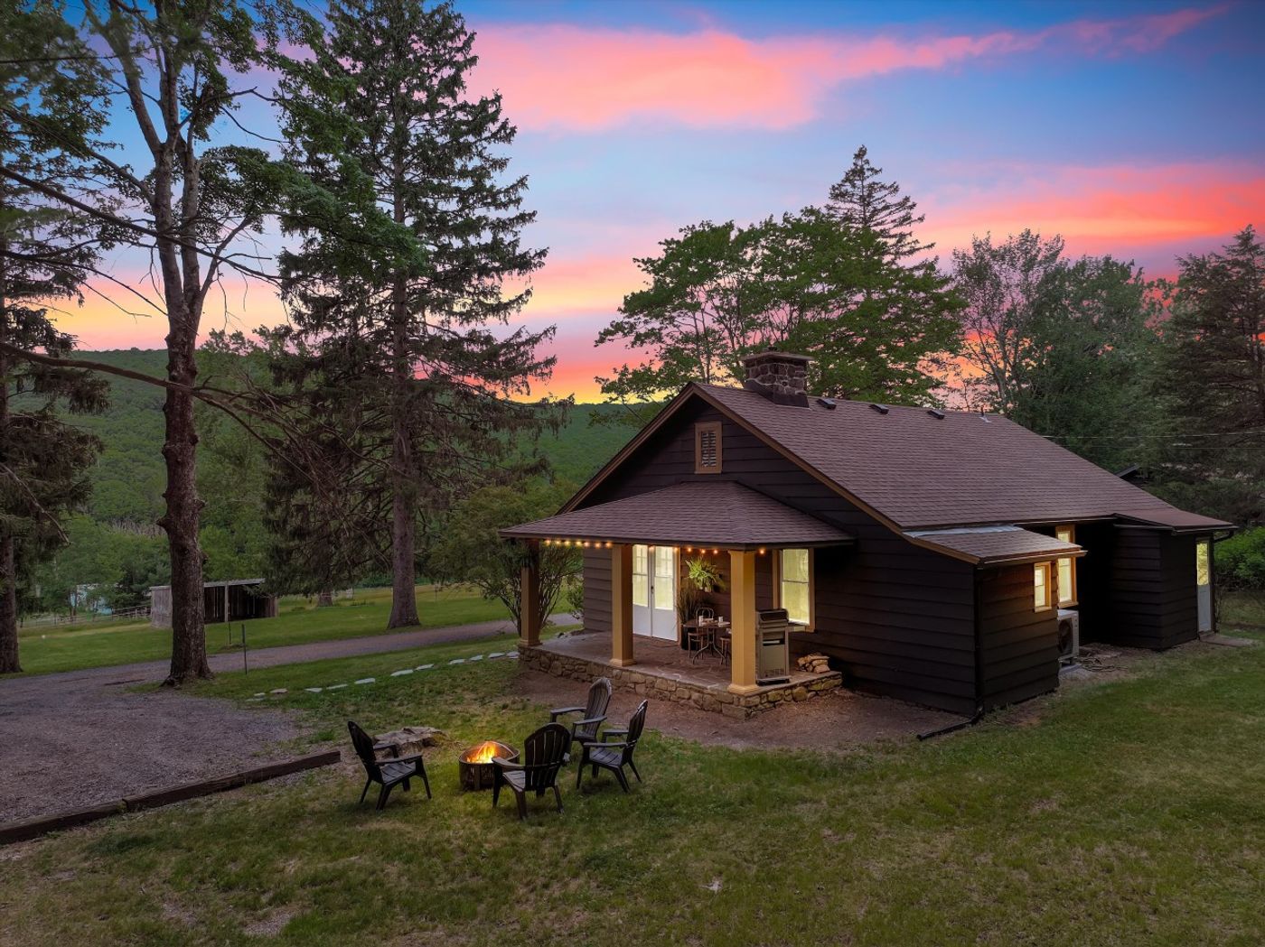The Mustang House at sunset, with a patio and chairs out front