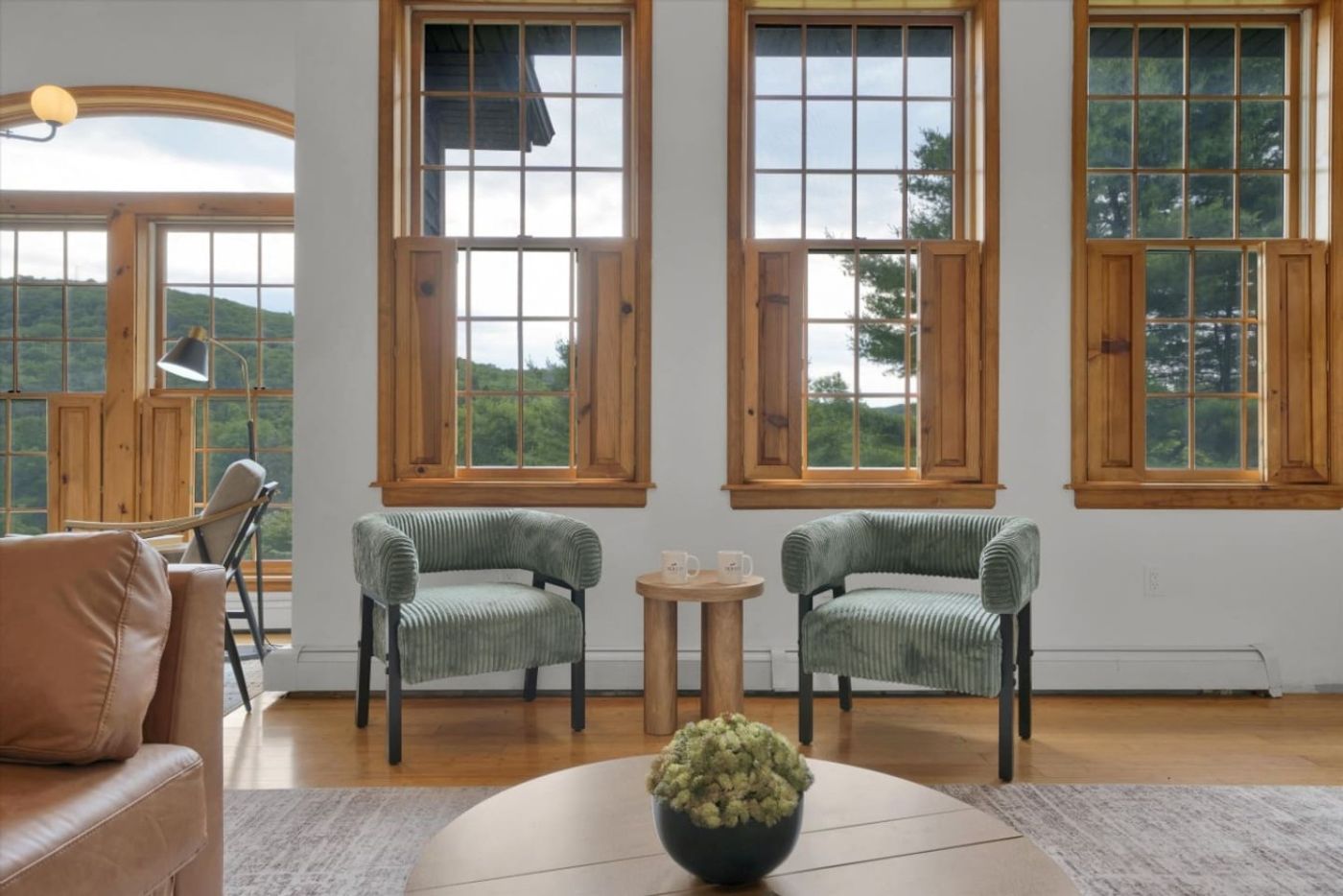 Sitting area with armchairs below tall windows