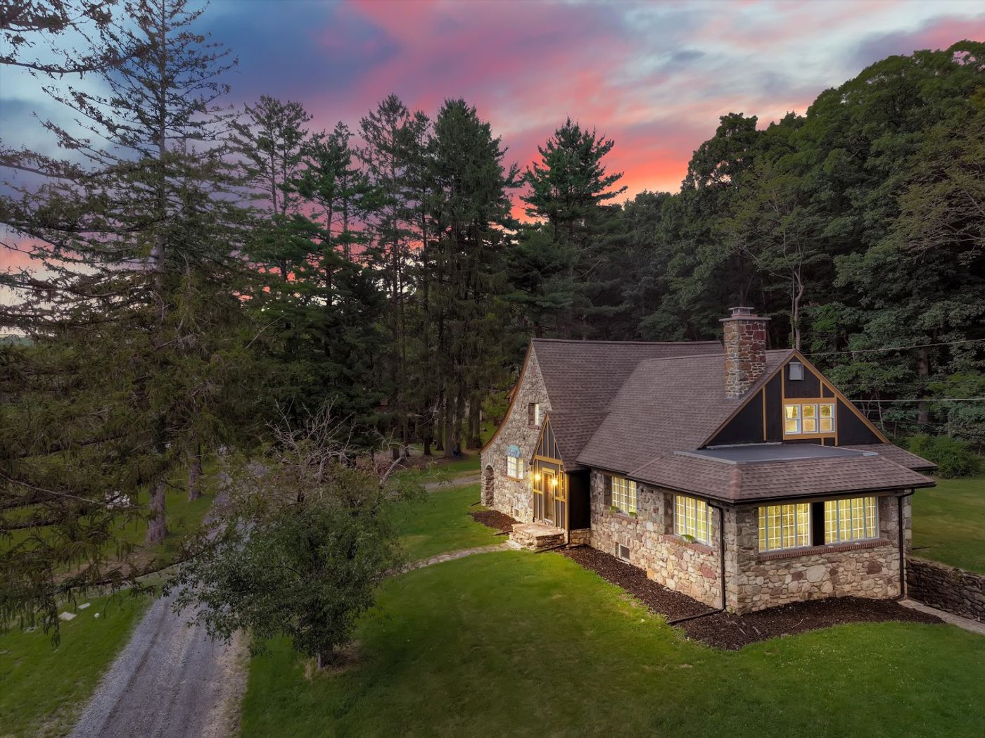 The Percheron House among the trees at sunset
