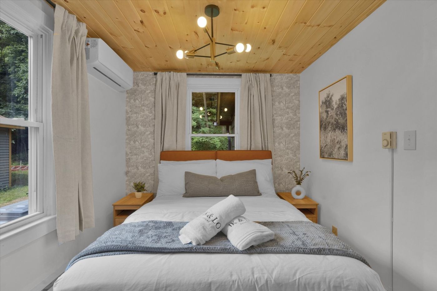 Bedroom with white bedding and wood ceiling