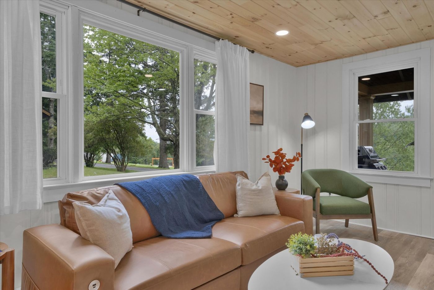 Living room with a tan sofa and colorful pillows