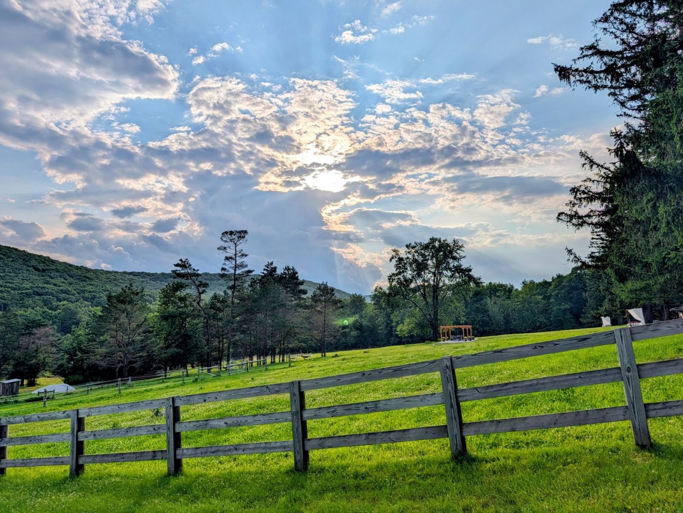 Split-rail fence and lawn at sunset