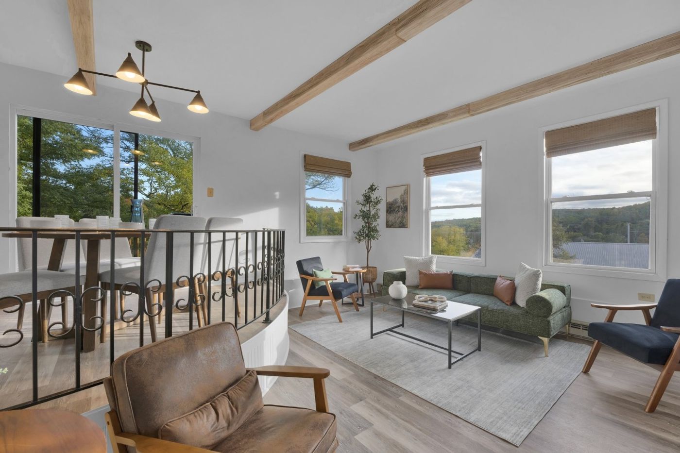 Open living, dining and kitchen area with wood beams