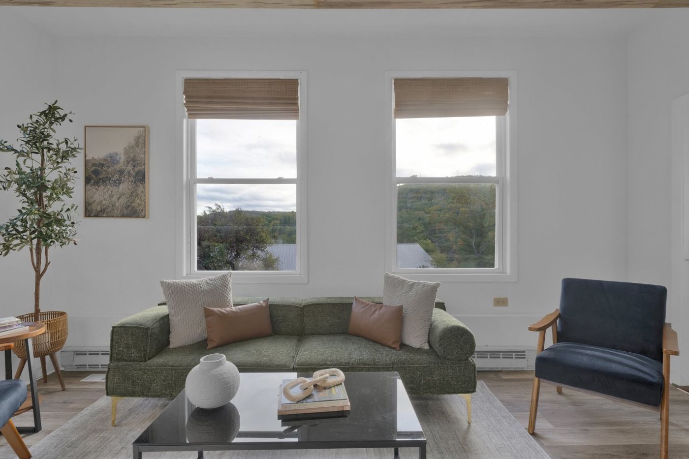 Sitting area with a sofa by the windows