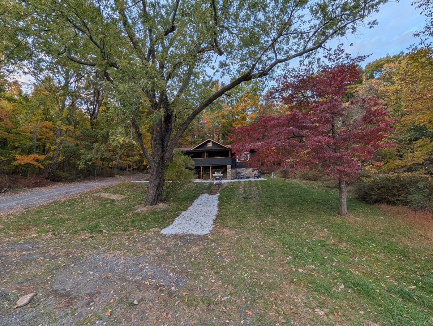 Lawn and trees in fall color outside the Pony House