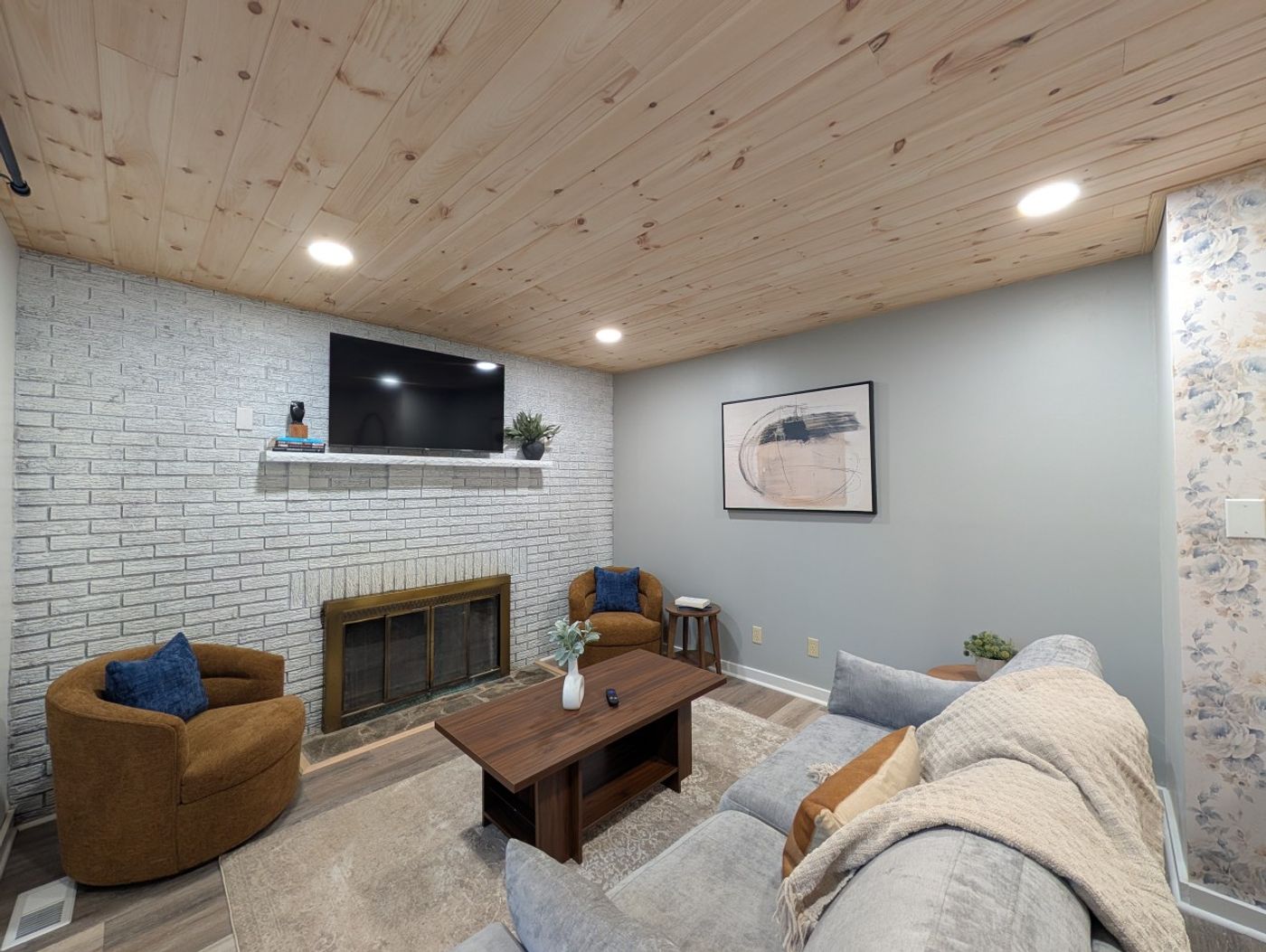 Living room with a white-brick fireplace