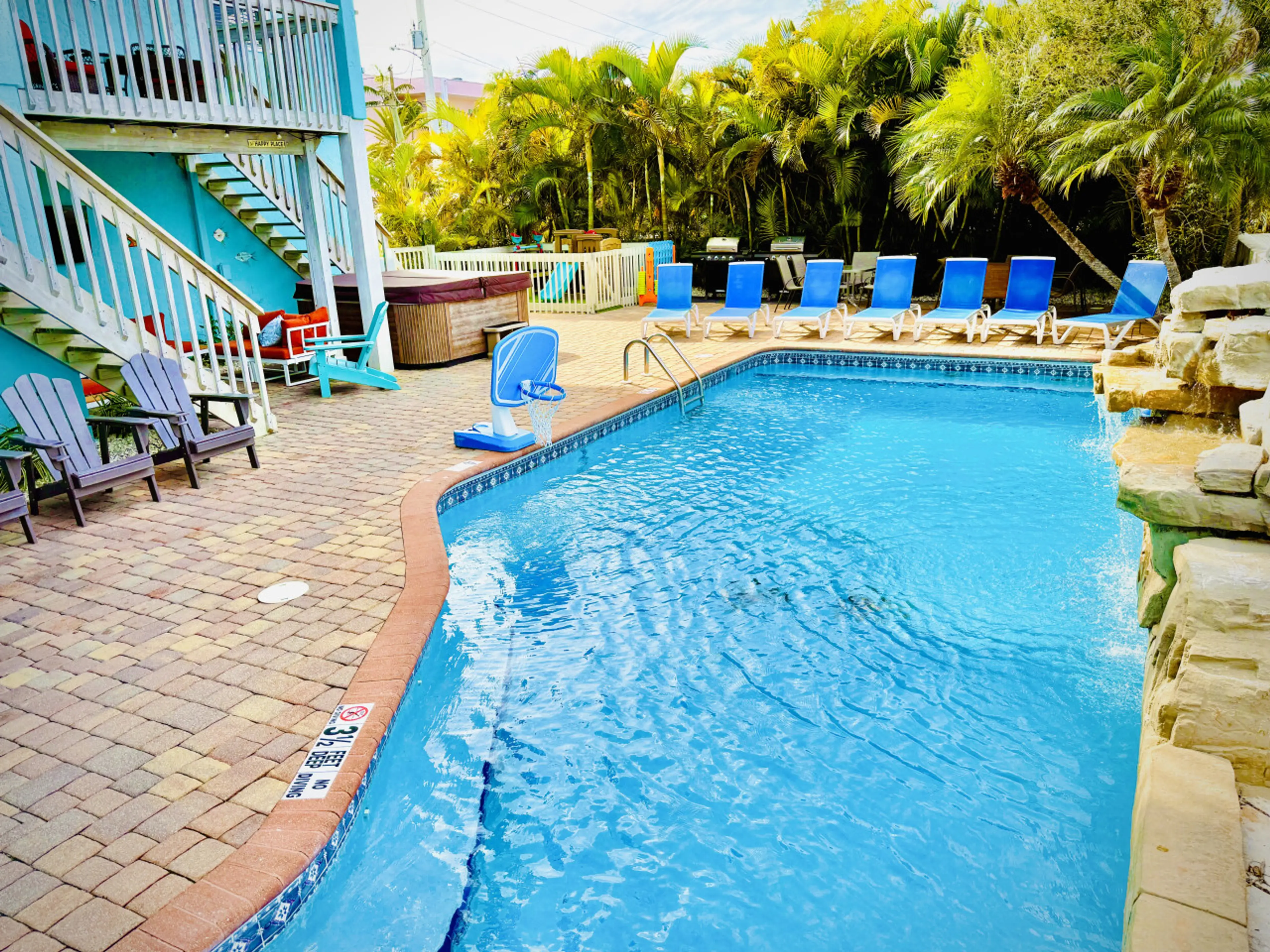 Pool view with waterfall and lounge area