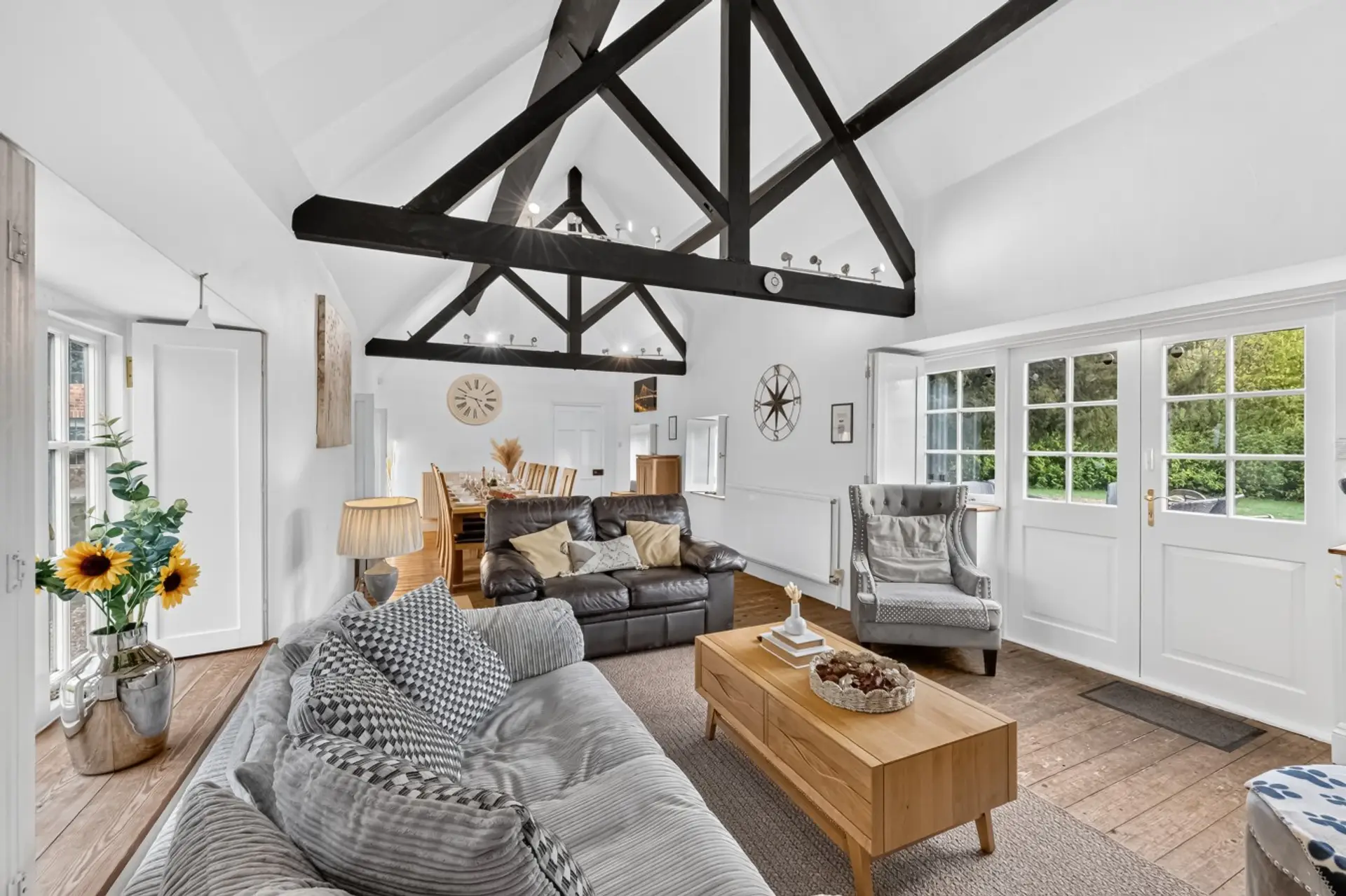 Relax and unwind in this stunning open-plan living and dining space, featuring beautiful exposed beams, vaulted ceilings and charming rustic touches. With comfortable sofas, a cosy seating area and a spacious dining table, it’s the perfect setting for rel