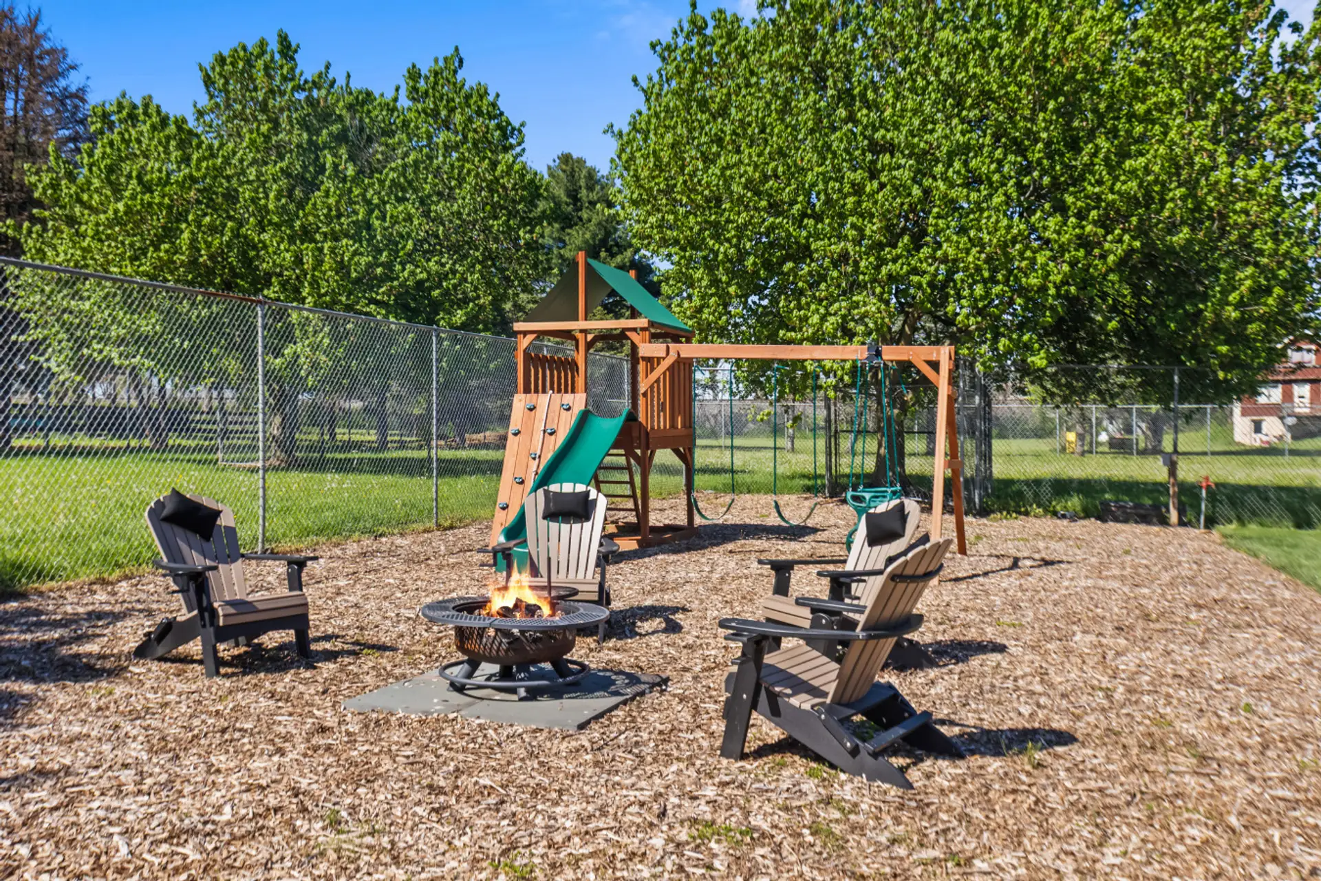 Backyard playground and firepit area
