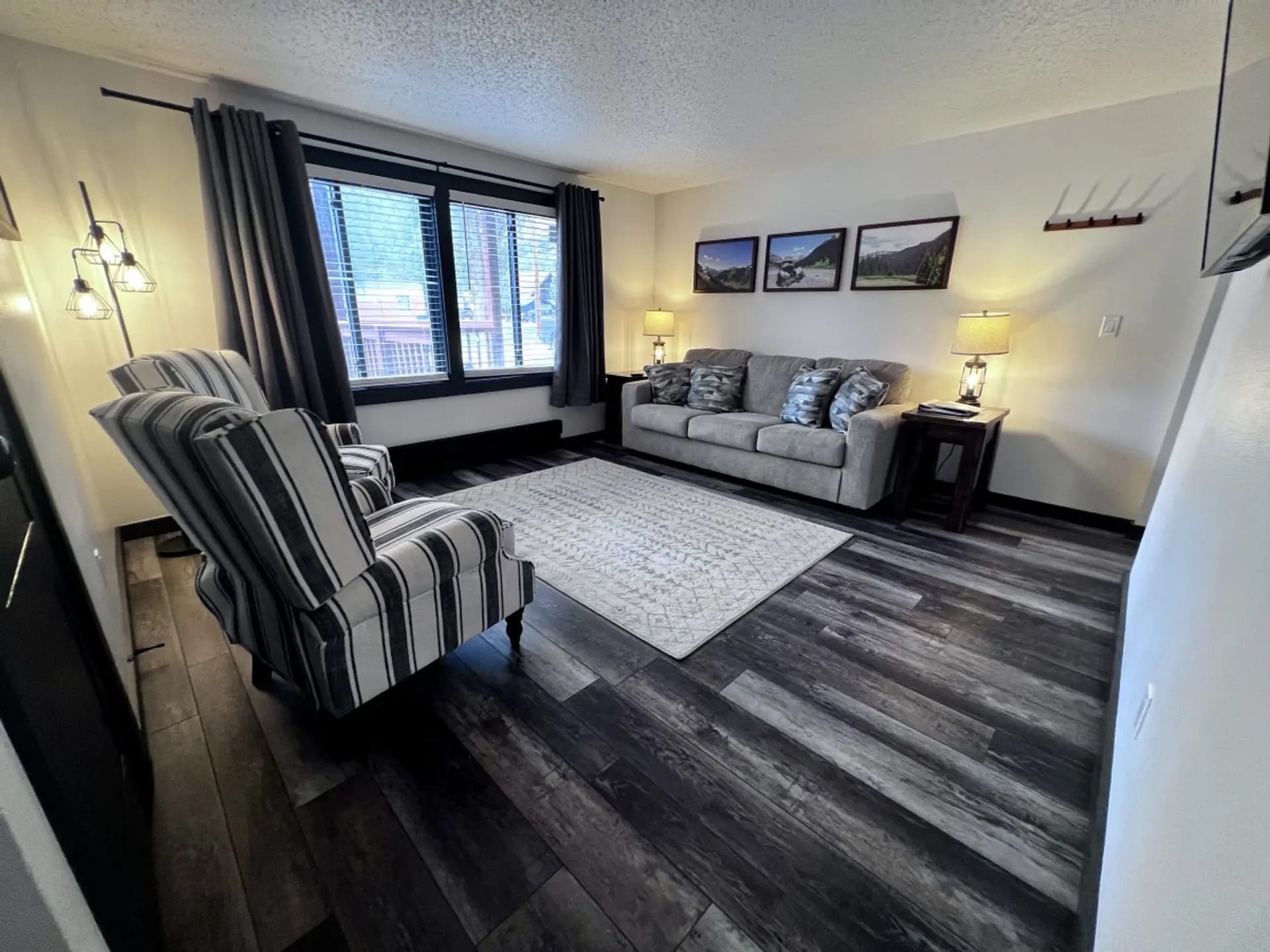 Living room includes 2 reclining chairs, queen size sleeper sofa, and Smart TV.
