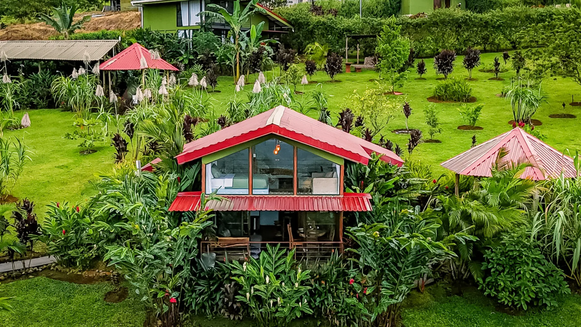 Birds Eye View of Cabin Exterior surrounded by beautiful gardens