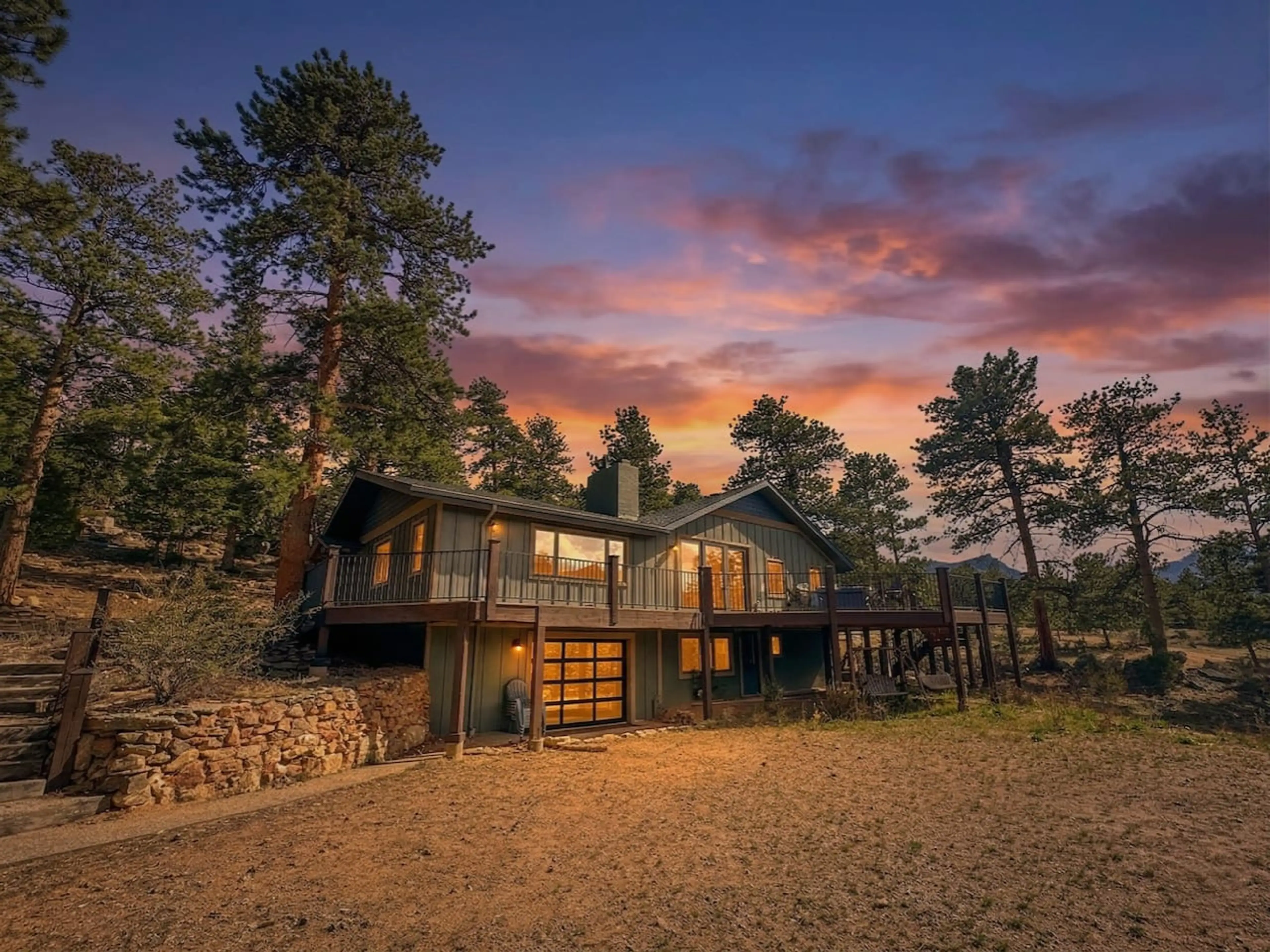 Sunset Lodge: modern mountain cabin in Estes Park, Colorado glows at dusk, just 10 minutes from Rocky Mountain National Park.