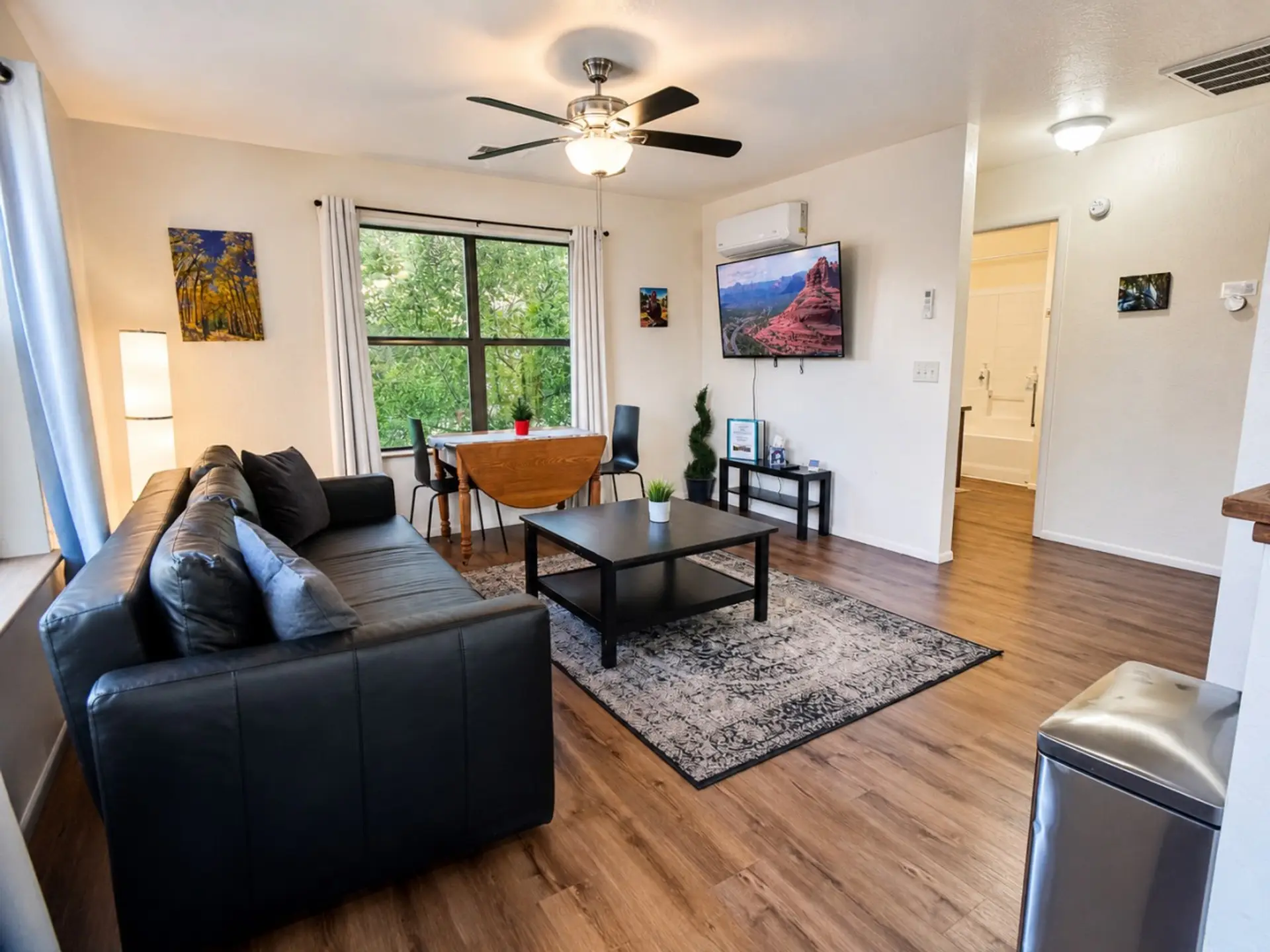 Bright living and dining area with mountain-town views, a comfortable couch, Smart TV, and easy space to unwind.