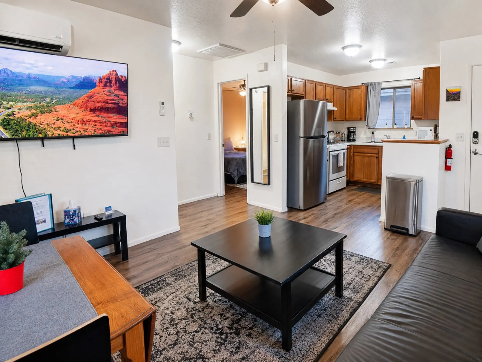 Clean, open condo layout with living room, kitchen, Smart TV, and easy access to the bedroom and bath.