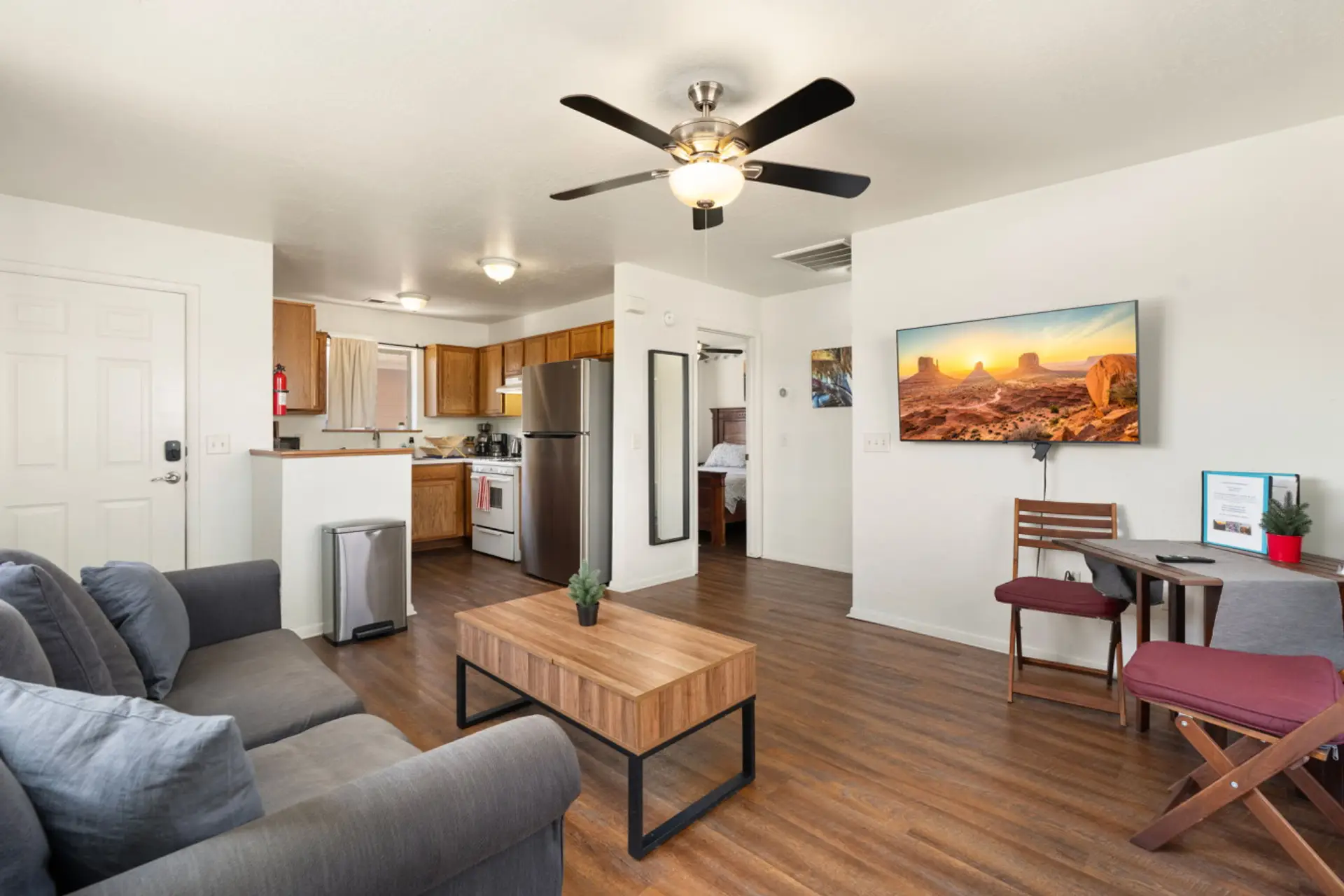 Easy, comfortable living space with Smart TV, dining area, and kitchen all in one open layout.