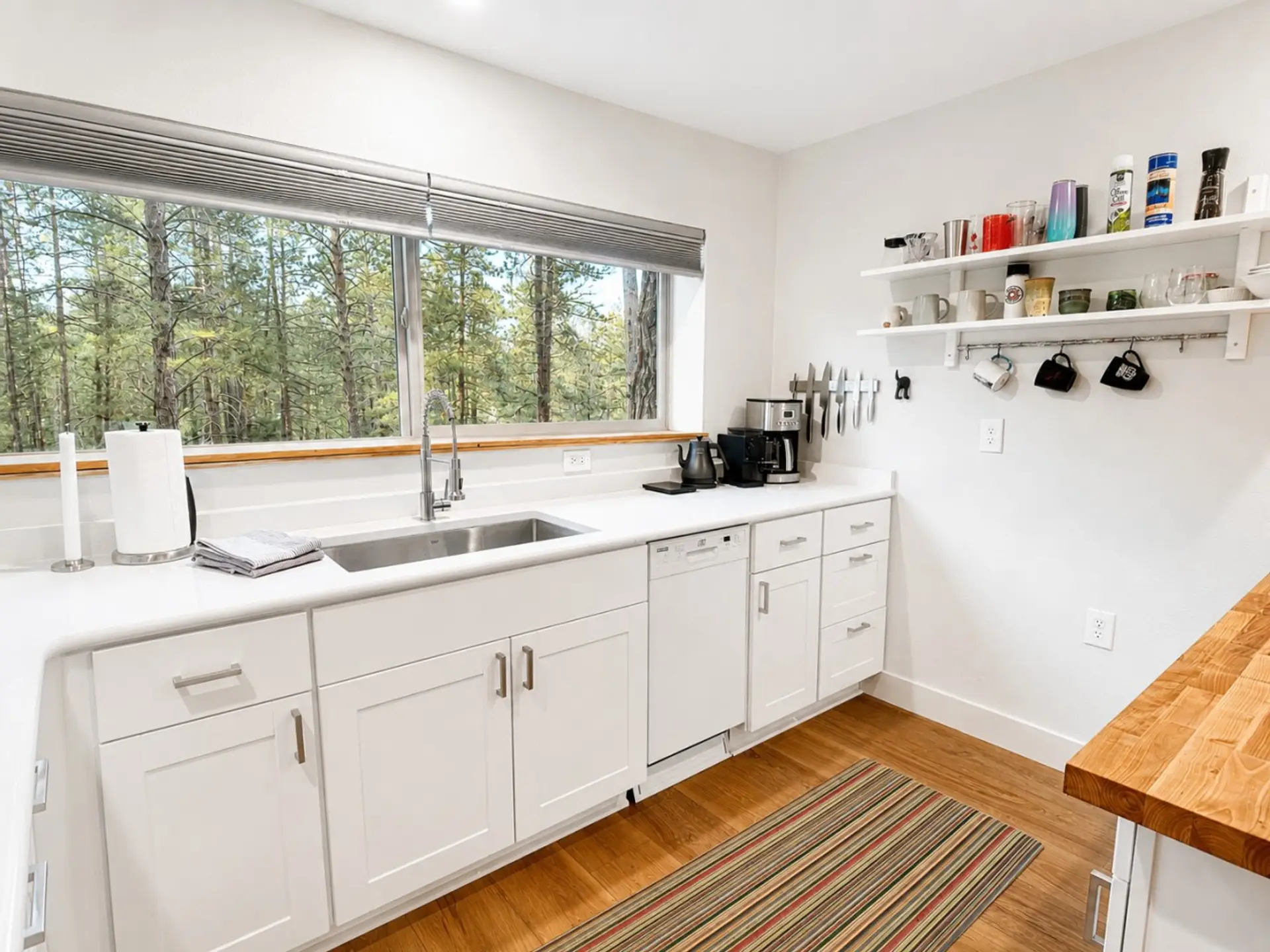 White quartz counters, a dishwasher, and quality tools make the kitchen easy to use.