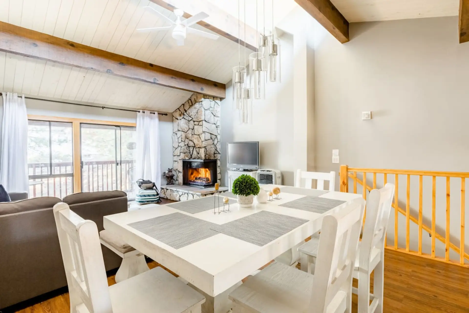 Spacious dining area with a table that seats up to six guests, all within an open floor plan that connects seamlessly to the living room and kitchen—perfect for shared meals and gathering together