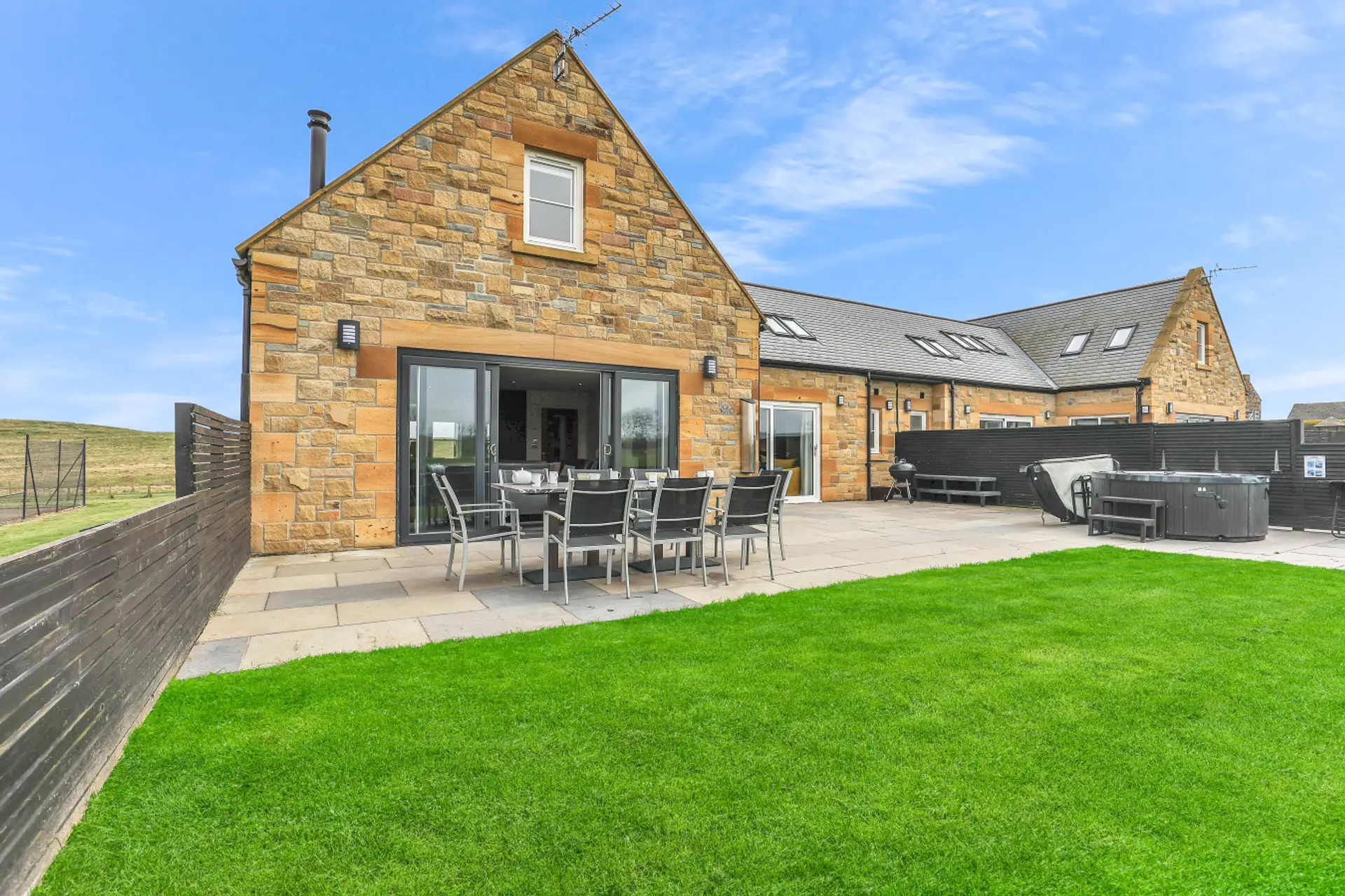Stone-built cottage with lawn, patio dining, and hot tub