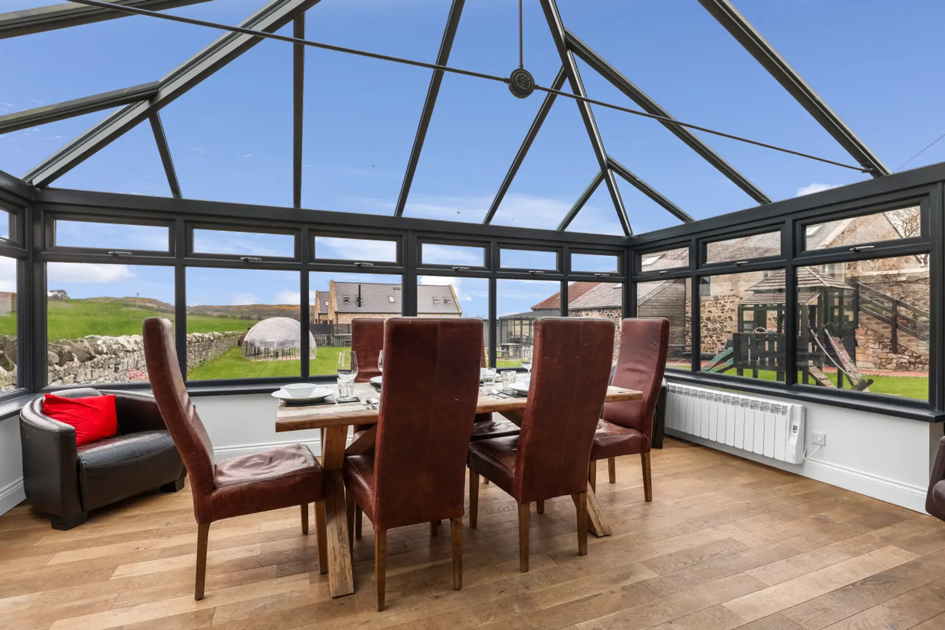 Conservatory dining area with countryside views and leather seating