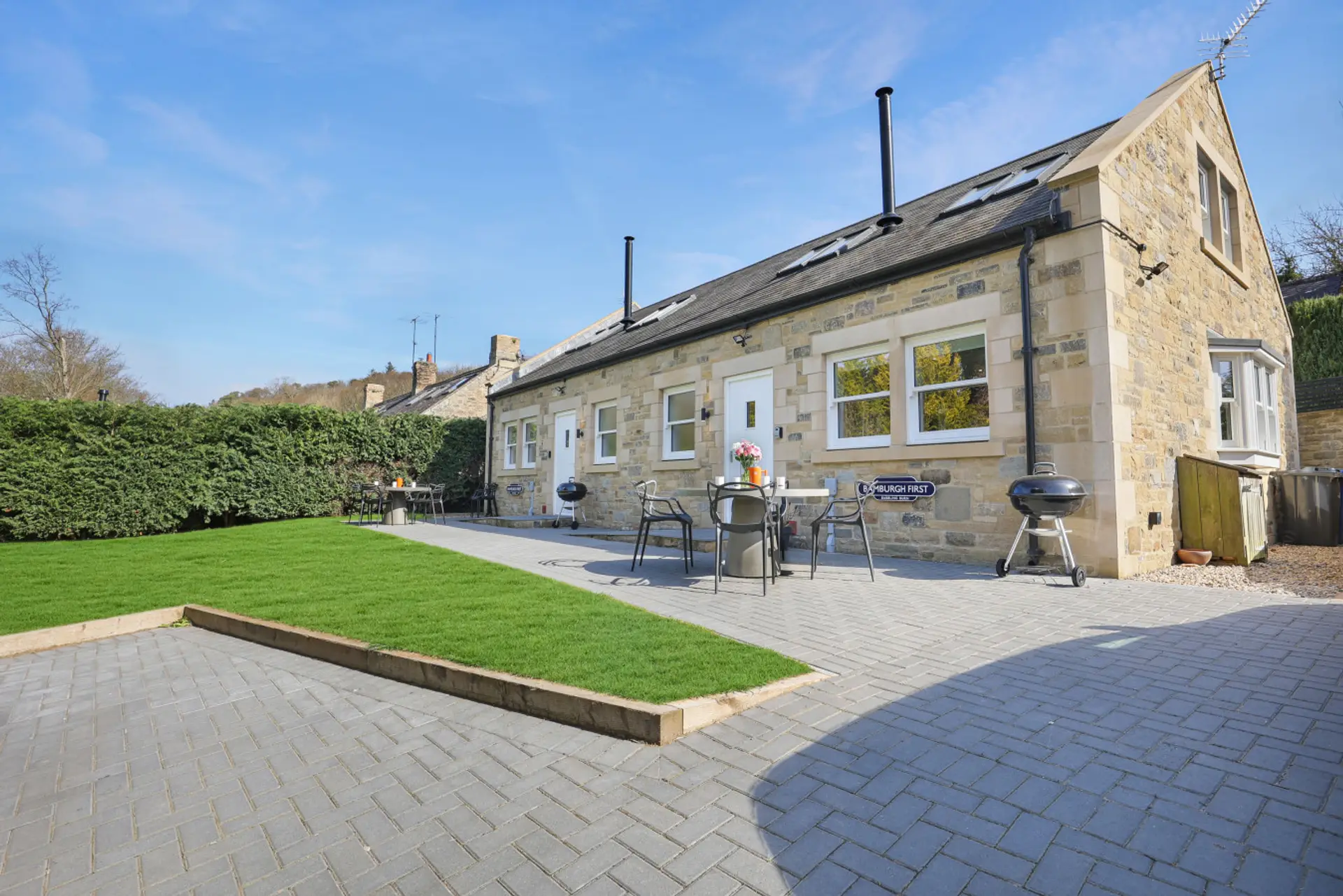 Stone-built cottage with patio seating and shared lawn